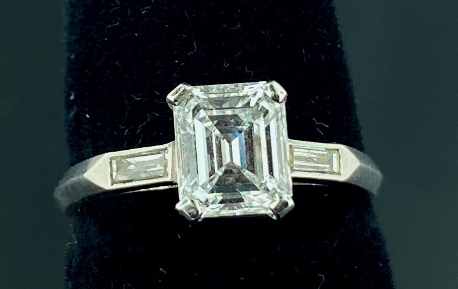 Set in Platinum is a 1.36 carat GIA Certified Emerald Cut Diamond, with 2 baguettes on the side weighing 0.20 carats.  GIA Certificate #1186504561.  Color is D.  Clarity is VS-2.  Ring size is 7.