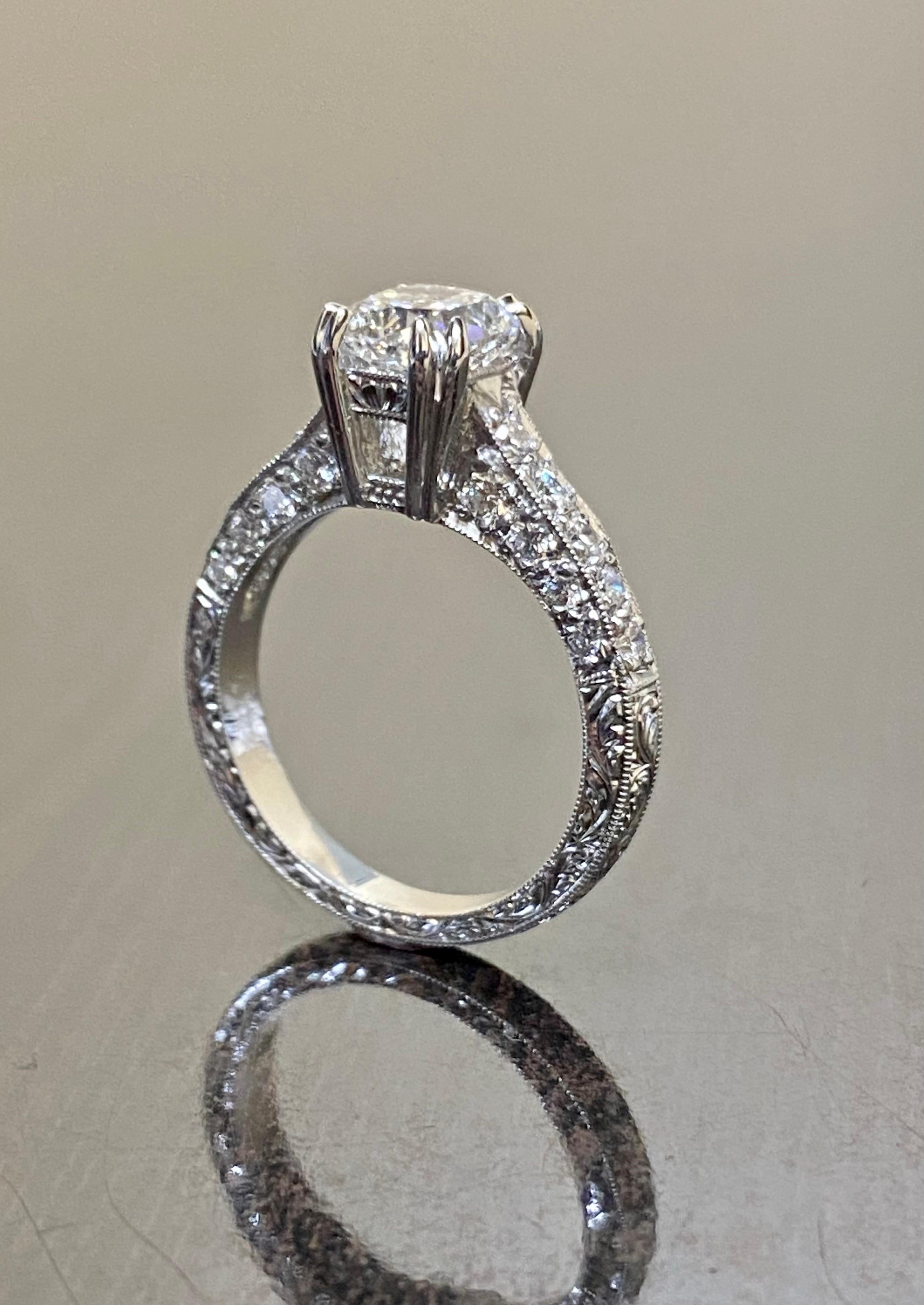 DeKara Design Collection

Handmade Art Deco Hand Engraved Platinum Cushion Cut Diamond Engagement Ring.

Metal- 90% Platinum, 10% Iridium.

Stones- GIA Certified Cushion Cut Diamond Center I Color SI2 Clarity 1.50 Carats, 26 Round Diamonds, G color