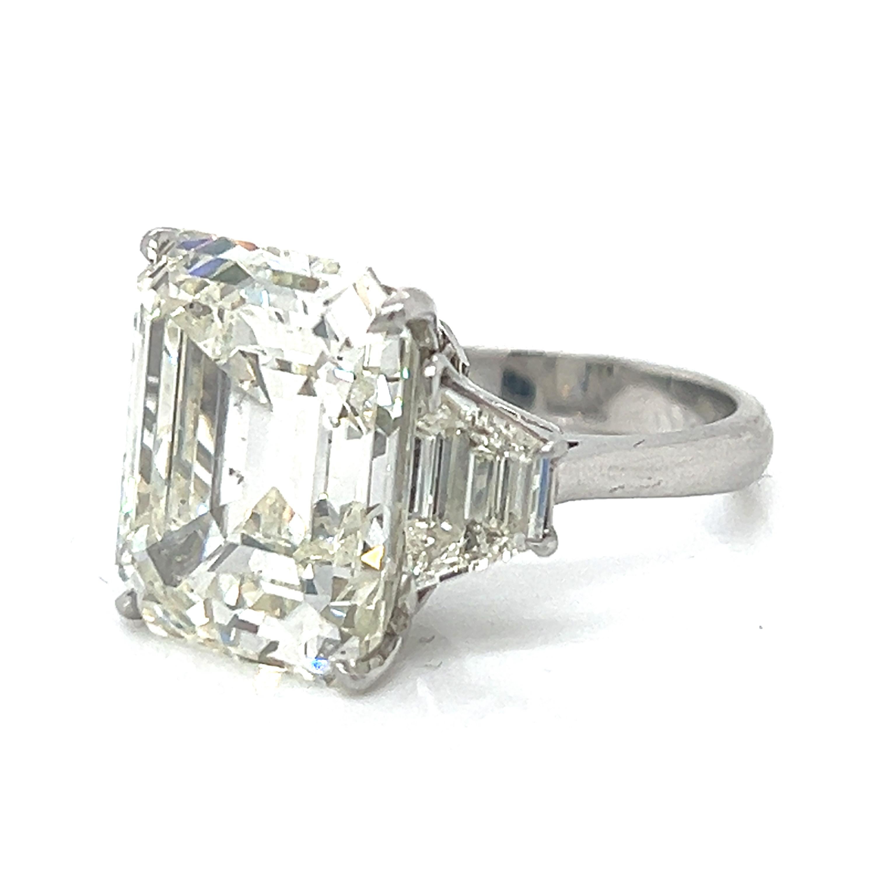 Platinum GIA Certified 15.22 Ct. Diamond Ring
Weighing 11.1 grams

Set with a GIA Certified 15.22 Ct. Emerald-cut Diamond
M Color, SI2 Clarity
GIA#2193901194

Along with 2 Diamonds weighing app. 1.40 Ct.
M-N Color, VS1-SI1 Clarity

This is a