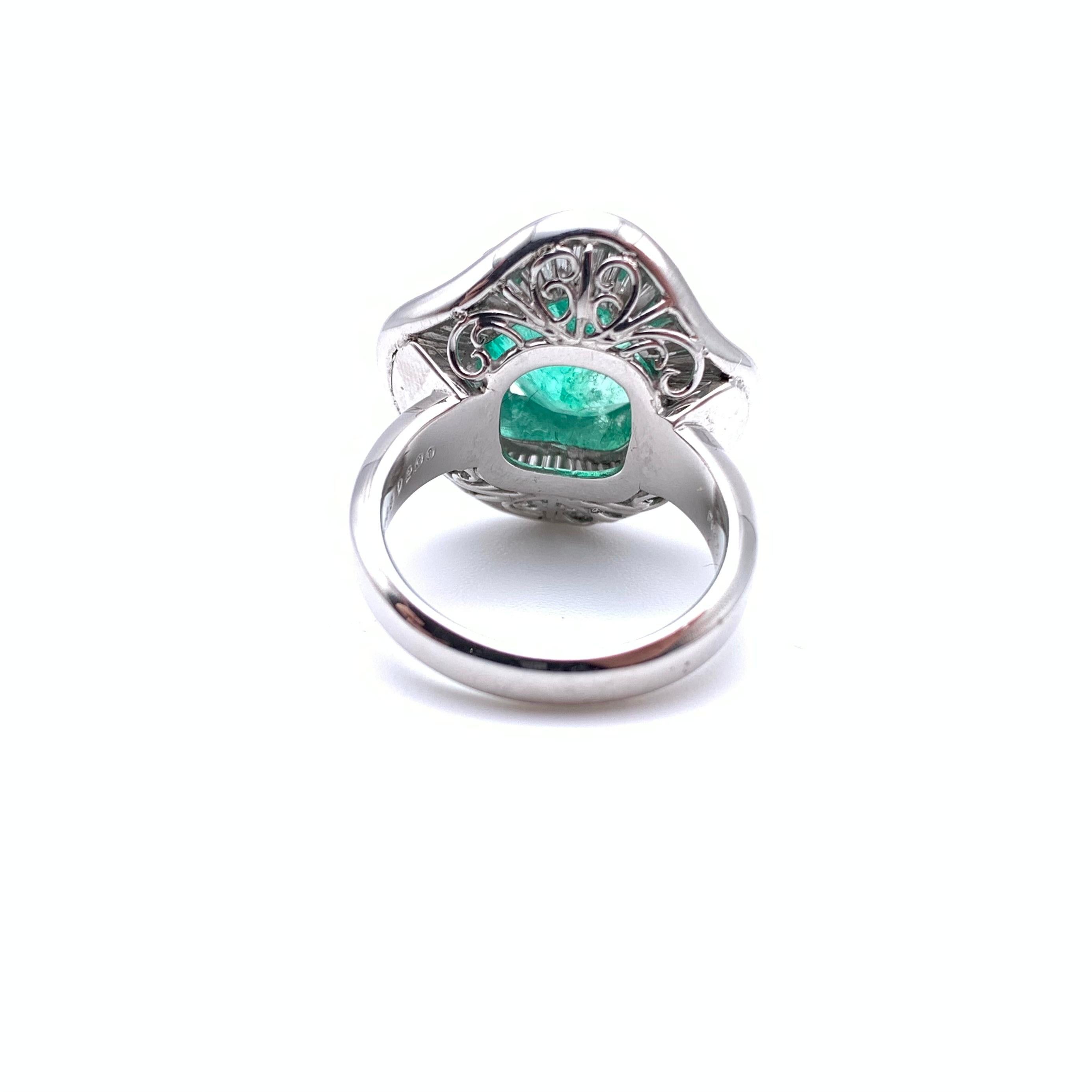 This classic ballerina ring is set in platinum. The center stone features one GIA-certified Columbian emerald measuring 4.37 carats. The outer halo contains 2.00 carats of baguette-cut diamonds grading SI in overall clarity and G-H in color. The