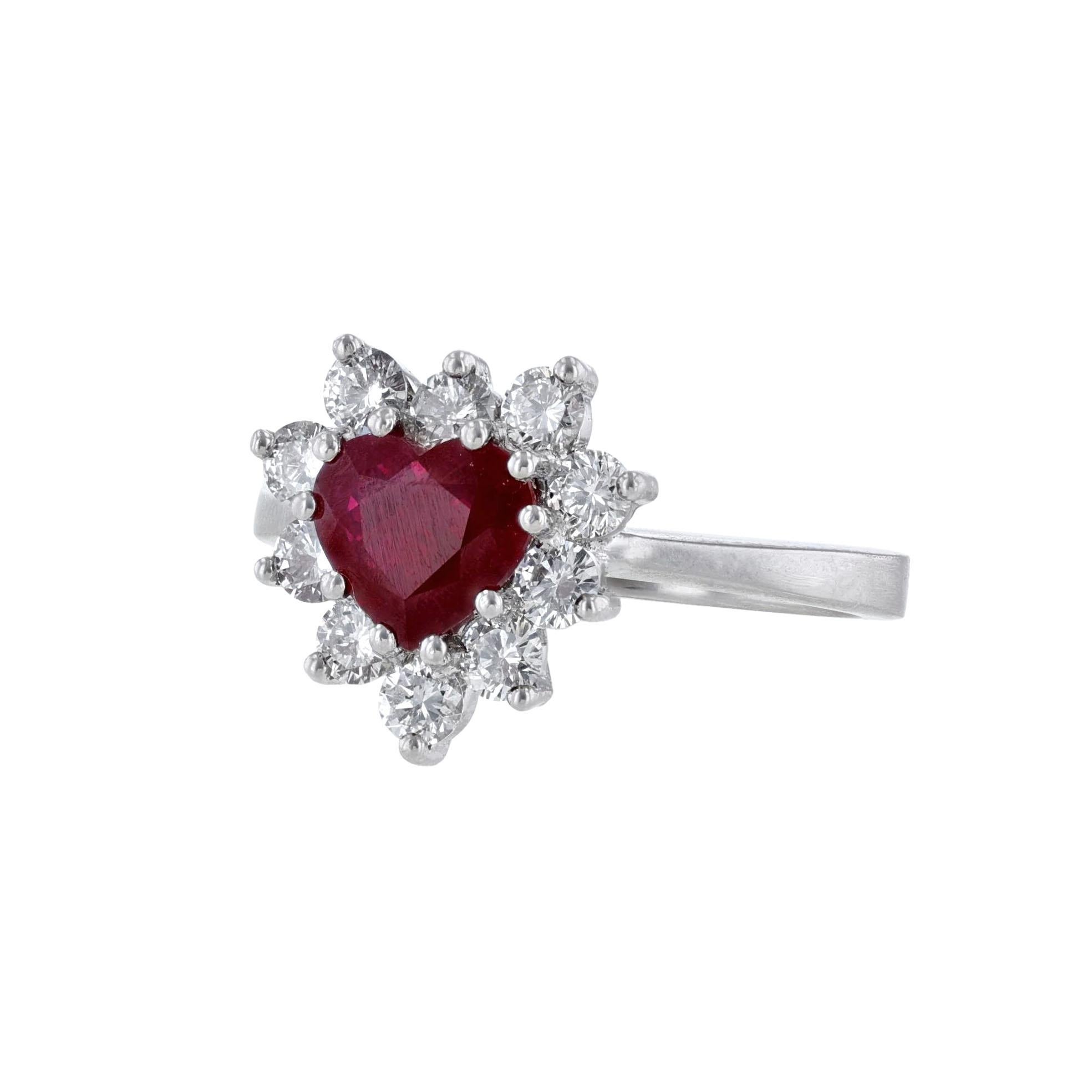 This ring is made in platinum. It features 1 heart-shaped Burma Vivid Red Ruby weighing 1.44 carat. The stone is GIA certified with GIA 6201265626. With a halo of 10 round cut diamonds weighing 0.83 carats. With a color grade (H) and clarity grade