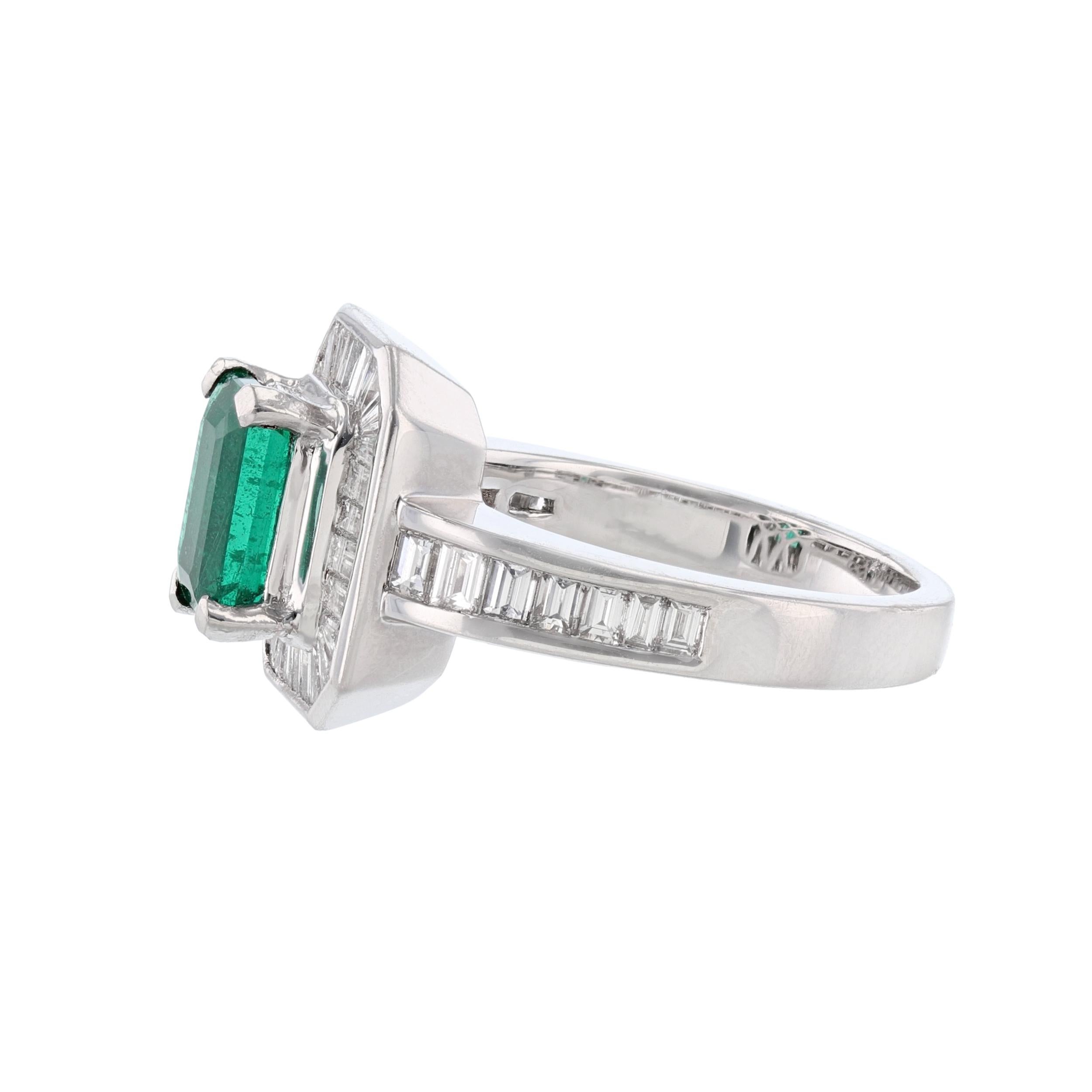 This ring is made in platinum and features an emerald cut, GIA certified emerald as the middle stone weighing 1.55 carats. The GIA certificate number is 2125281009. The ring also features 43 channel set, baguette cut diamonds weighing 1.23 carats.