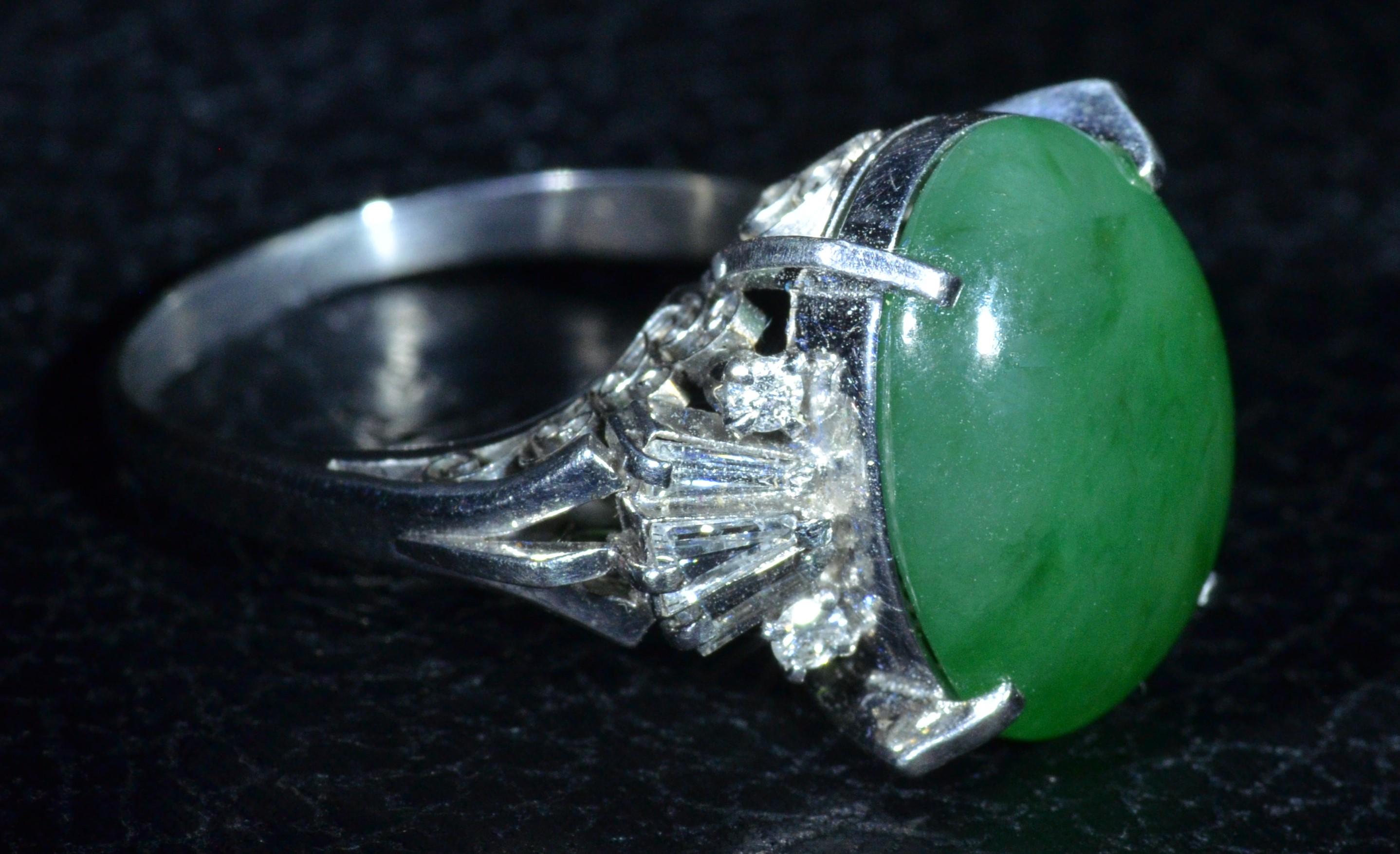 Platinum Filigree ring set with 12 carat natural GIA Graded Jadeite Jade Ring set with Diamonds Finished with filigree undercarriage! The center Jadeite Jade exhibit's a beautiful green and outstanding luster!  On either side of the center are round