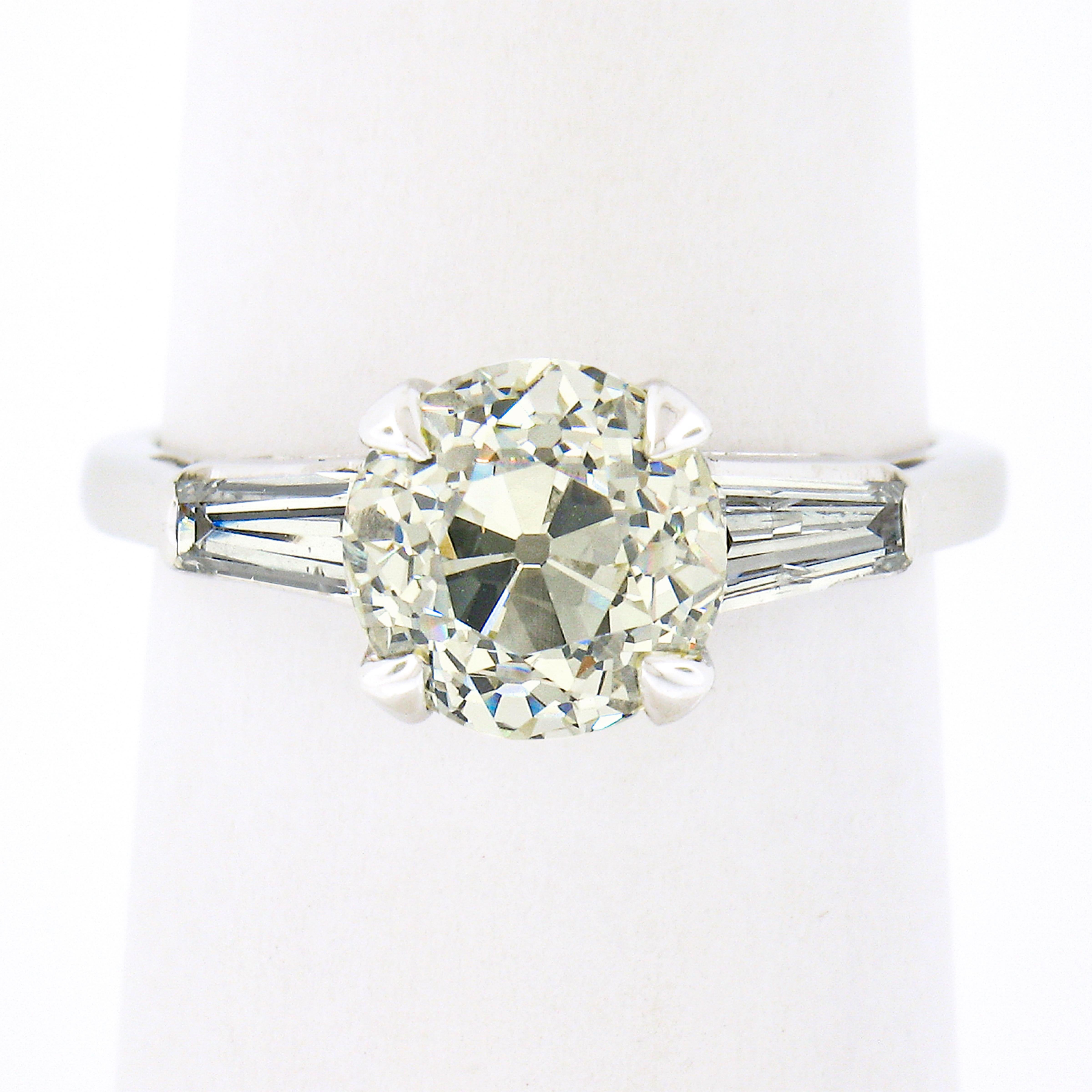 You are looking at a truly breathtaking vintage engagement ring that is crafted from solid platinum and is set with a GIA certified, early old European cut light yellow diamond. This chunky old cut center diamond is certified at exactly 2.36 carats