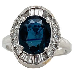 Platinum GIA Oval Cut Blue Heated Sapphire w Baguette & Round Diamond Halo Ring