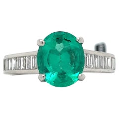 Platinum GIA Oval Cut Colombian F2 Emerald with Baguette Cut Diamond Ring