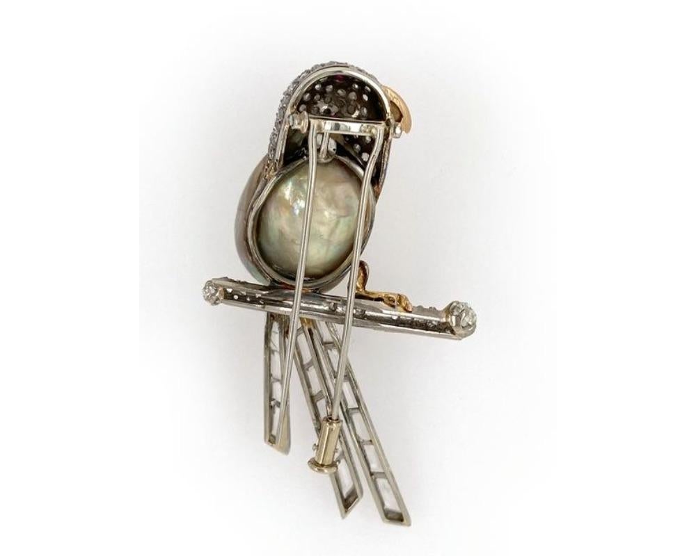 Platinum pearl diamond ruby eye, sapphire tail 18K rose gold beak bird pin. old mine and rose cut diamonds, measures 2 1/4 x 1 1/4 inches, weight 12.2 dwt