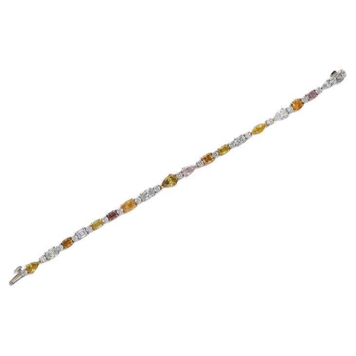 Composed of Fancy Colored diamonds and diamonds.
- Diamonds weighing a total of 11.07 carats
- Platinum and 18 karat yellow and rose gold
- Total weight 17.35 grams
- Length 6¾ inches
- Accompanied by 14 GIA reports:
1. GIA 5151476458, 
2. GIA