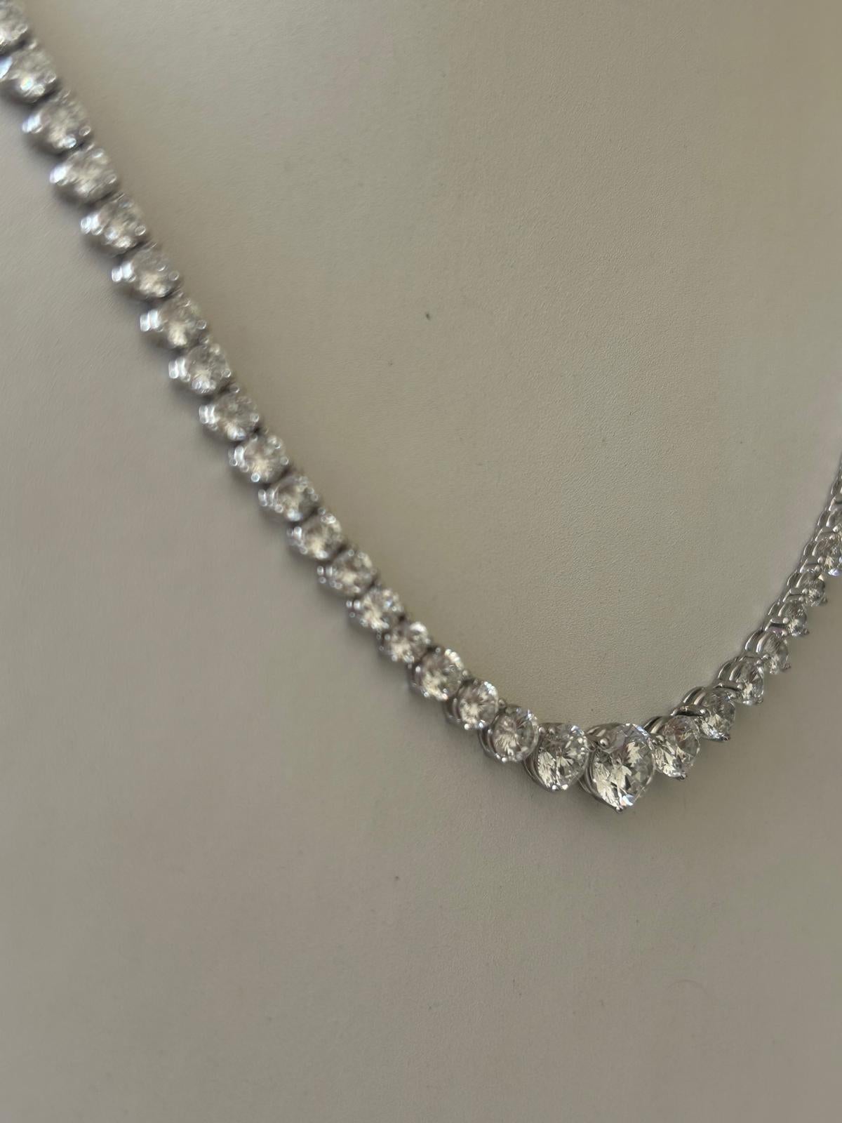This exquisite necklace features a seamless line of natural round brilliant diamonds set in solid platinum (27 grams). The design showcases a graduated layout, starting with a stunning 1.00 carat center stone, tapering down to delicate 0.10 carat