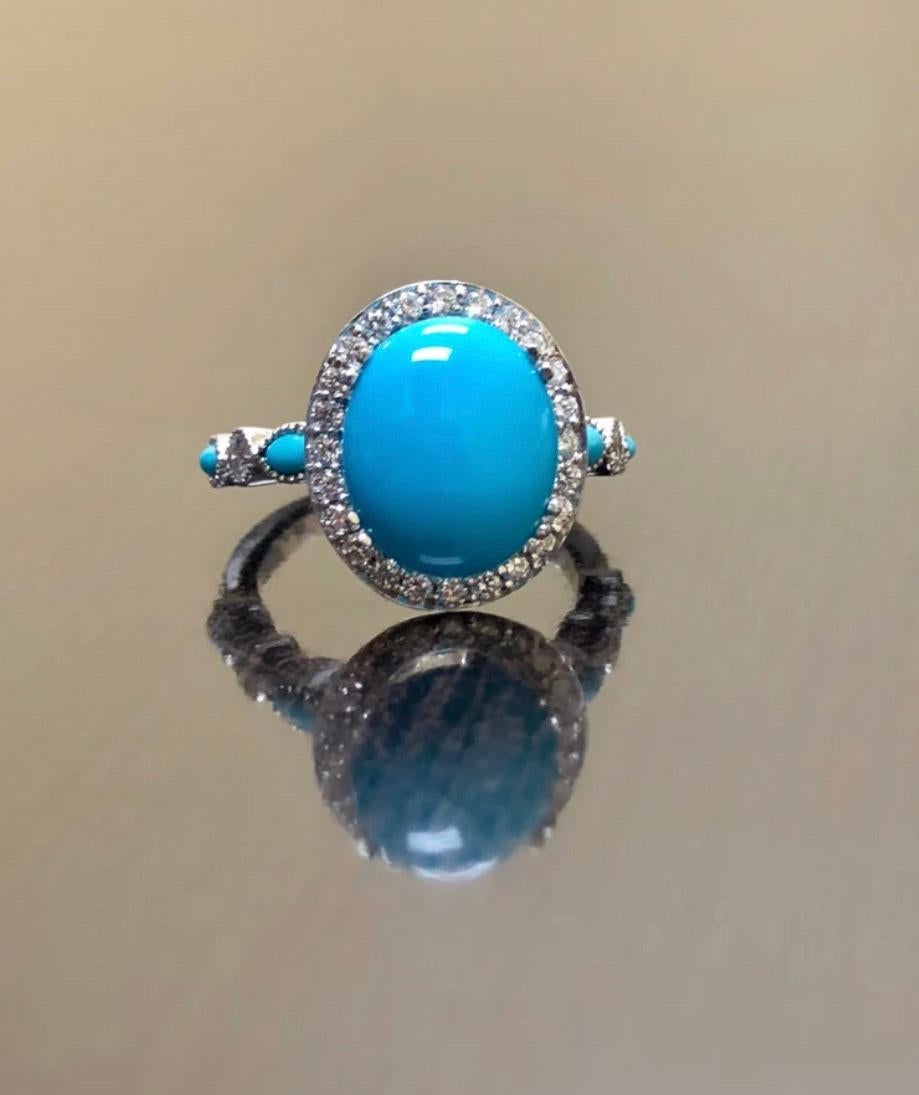 DeKara Designs Collection

Metal- 90% Platinum, 10% Iridium.

Stones- Center Features a Sleeping Beauty Turquoise Cabochon Cut 12 x 10 MM 2.20-2.50 Carats, Four Marquise Turquoise, 32 Round Diamonds F-G Color VS2 Clarity, 0.40 Carats.

Size-