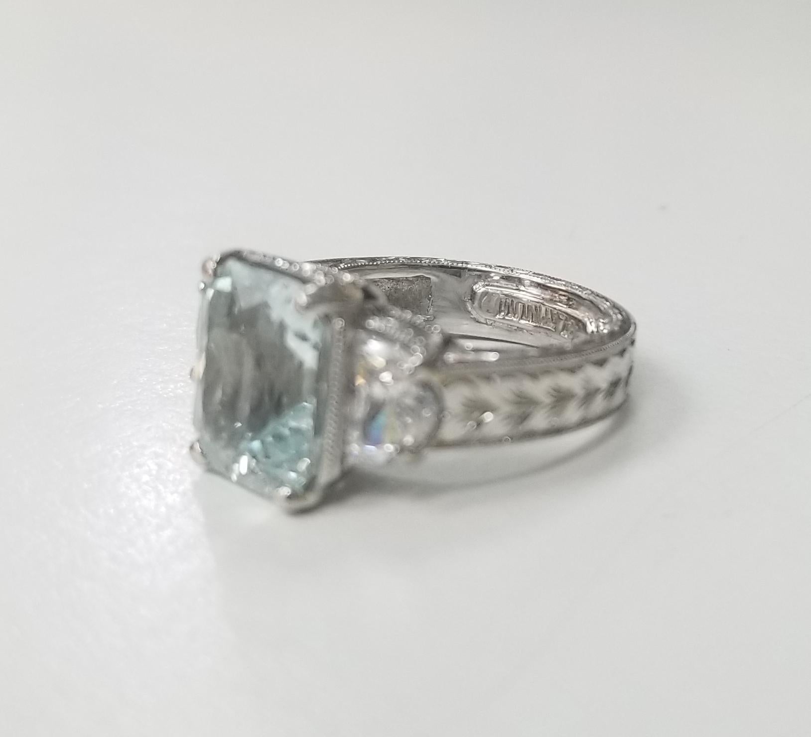 Platinum hand engraved Aquamarine with half moons, containing 1 emerald cut aquamarine measuring 8 x 10 mm (approx. weight 6cts), with 2 half moons, ring size is 3.75