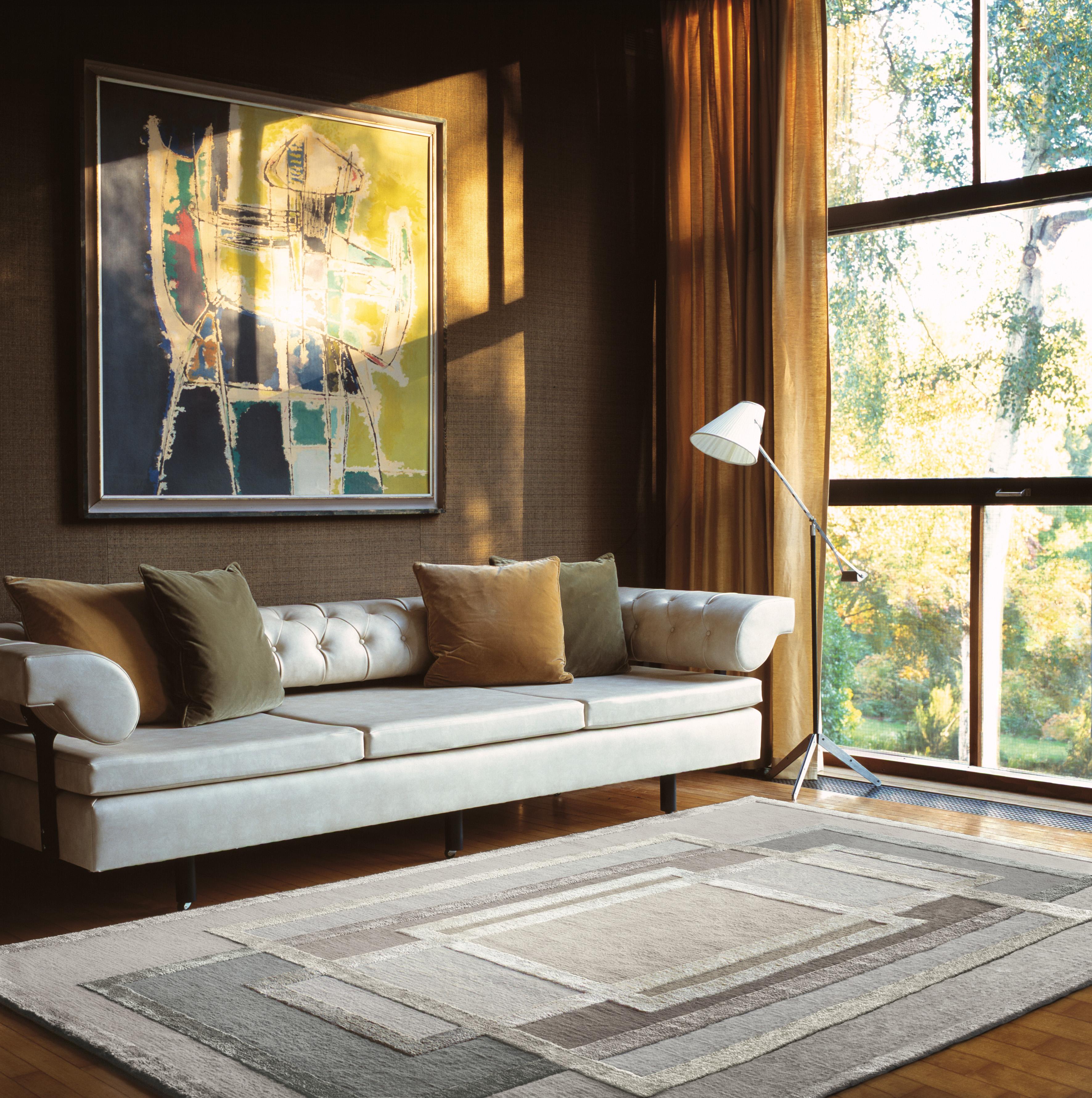 Our platinum rug designed by David Rockwell, is hand knotted in a tactile blend of Tibetan wool and silk. The luxurious color palette of shimmering metallic tones complements the graphic, textural design, lending it a glamorous