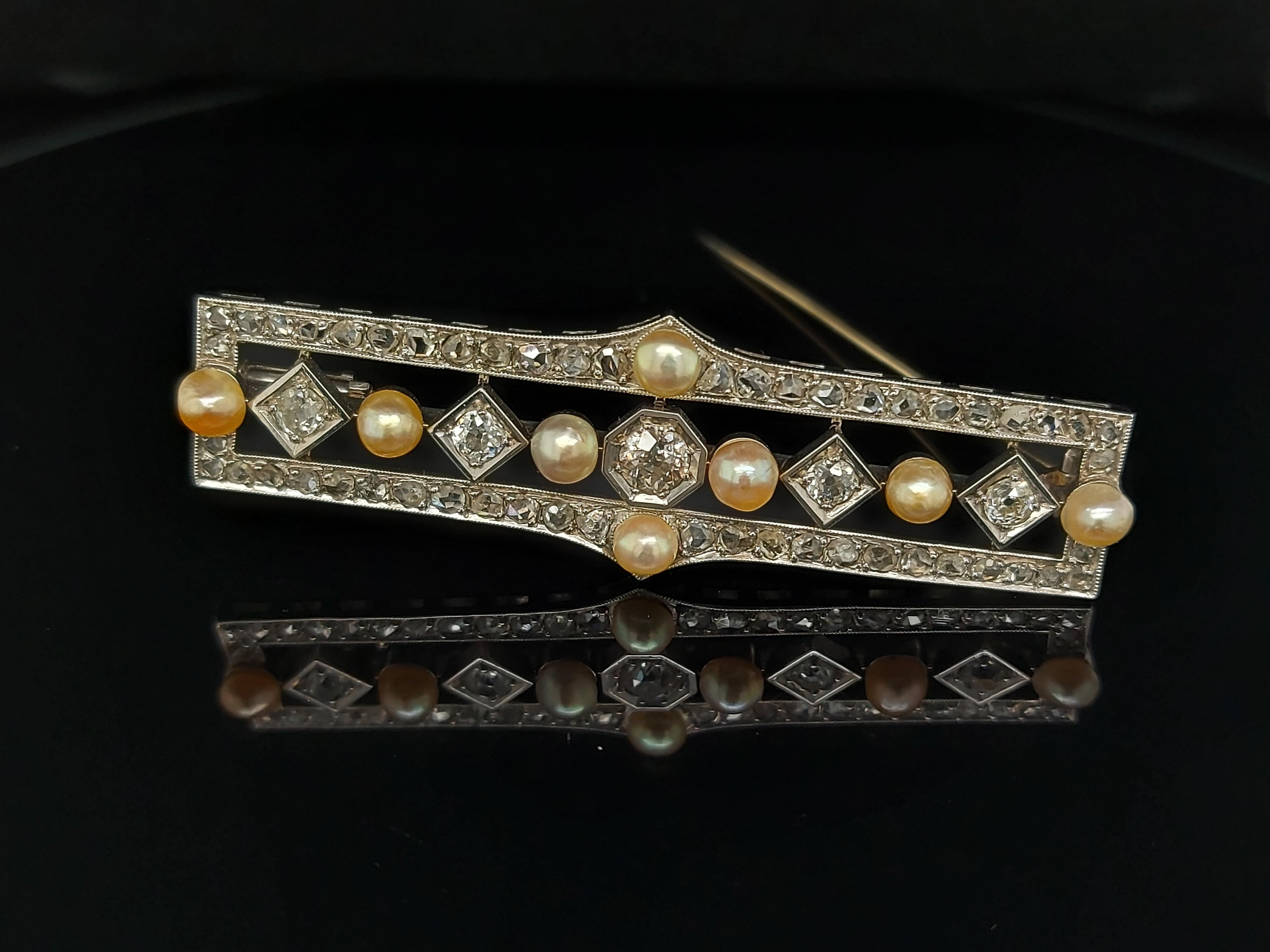 Platinum Hand Made Bar Brooch with Diamond and Pearls 

Pearls: 8 beautiful natural pearls with a diameter of approx. 4 mm.

Diamonds: The largest 5 diamonds are in an Old Mine cut:
1 stone of 0.36 ct
4 stones of 0.12 ct each .Total 0.48 Ct
Another
