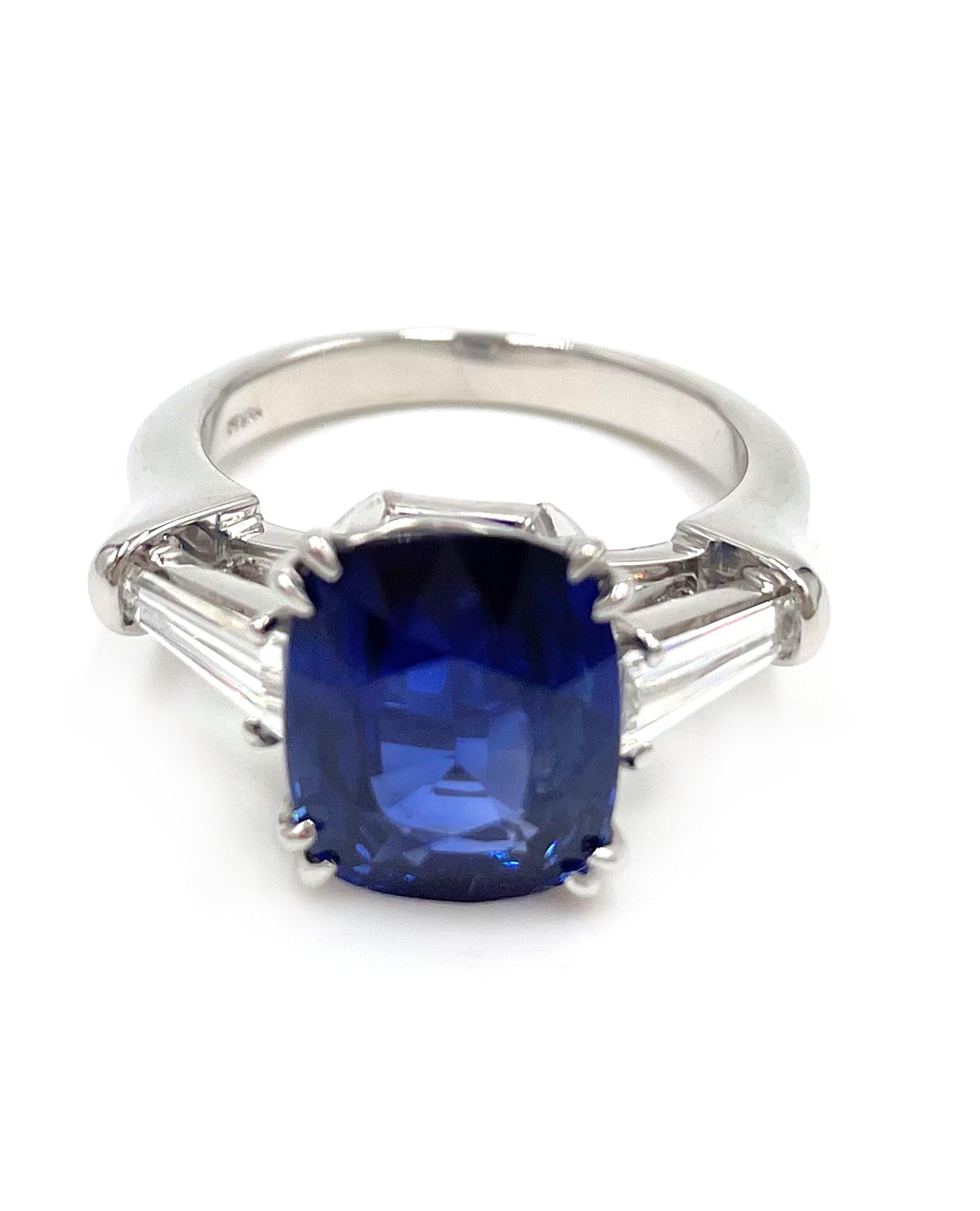 Platinum hand made ring with two tapered baguette diamonds totaling 0.56 carats (G color / VS clarity) and one center cushion cut Ceylon sapphire 5.14 carats. 

* Includes certificate for center stone
* Finger size 7. Can be resized.
