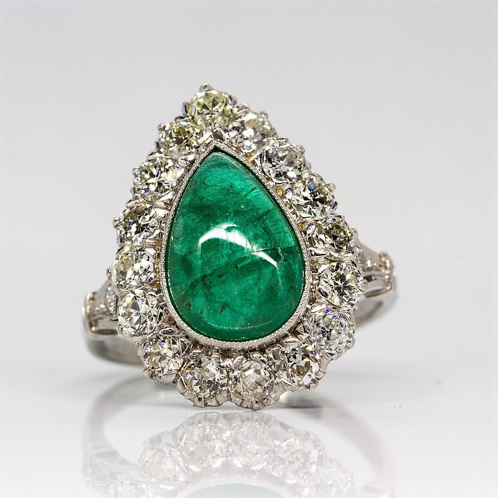 Composition: Platinum
Stones:
•	1 Natural pear shape emerald 3.10ctw.
•	18 Old mine cut diamonds H-VS2 1.38ctw
Ring size: 7
Ring face measurement:  20mm by 15mm.
Height: 7mm.
Total weight:  6.8 grams – 4.4dwt
