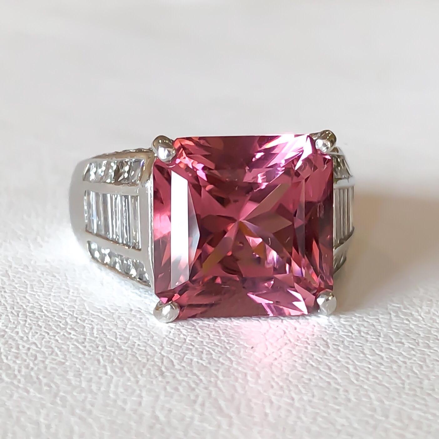 This ring is designed by J.B. STAR in Platinum set with a vibrant natural pink Tourmaline. The Tourmaline is a fancy mixed princess cut shape set in four prongs. Pave set round brilliant cut diamonds, channel set princess and straight baguette cut