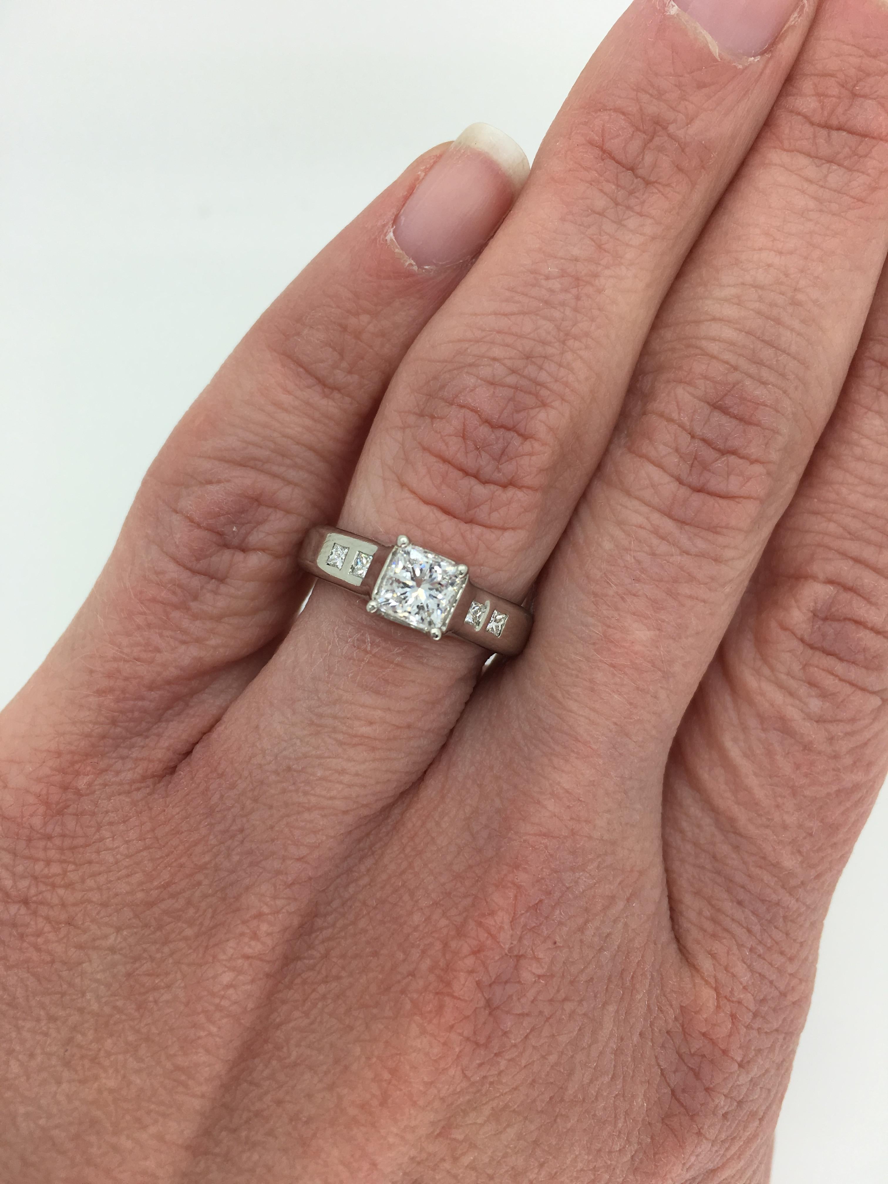 “Eden Engagement Ring” from designer Jeff Cooper’s “Ever Collection”.  The Platinum ring features a beautiful AGS Certified .82CT Princess Cut Diamond. The featured diamond displays E-F color and SI1 clarity. There are four additional Princess Cut