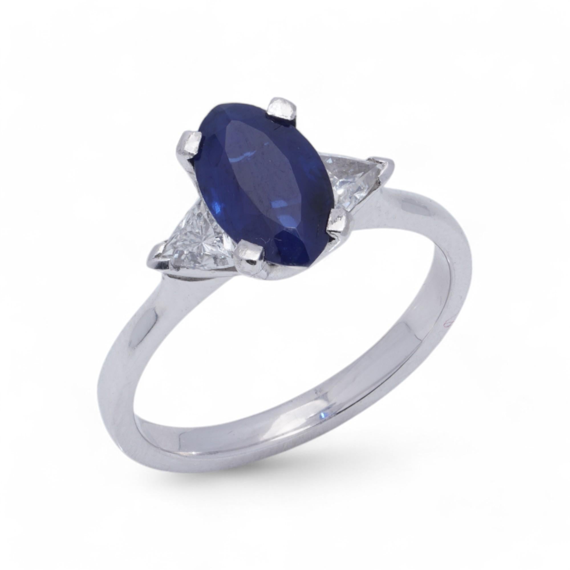 Platinum Ladies Ring with Blue Sapphire and Trillion Cut Diamonds

This stunning platinum ring features a 1-carat marquise-cut natural blue sapphire with a vibrant royal blue hue. The sapphire is flanked by two trillion-cut diamonds, each weighing