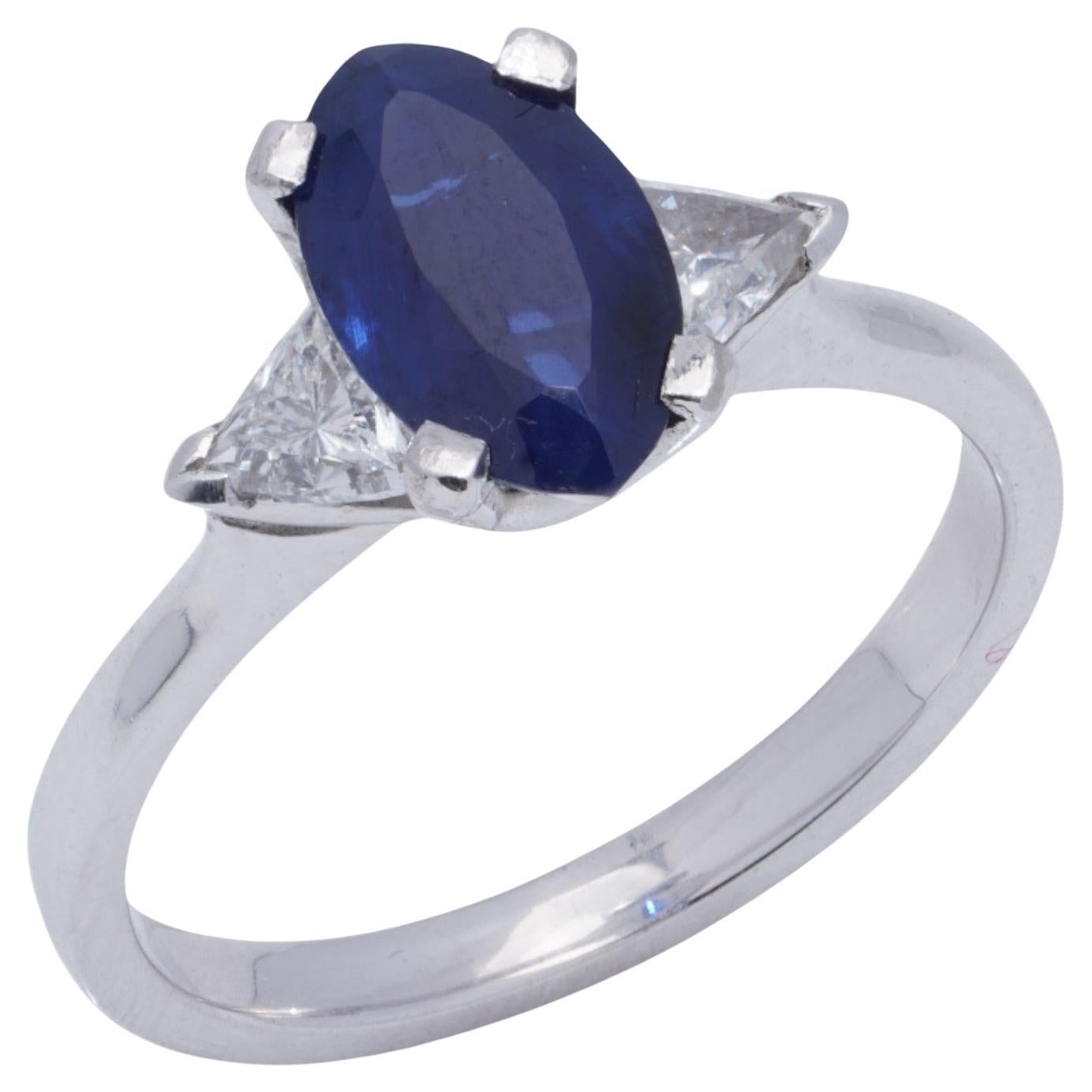 Platinum Ladies Ring with Blue Sapphire and Trillion Cut Diamonds For Sale