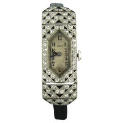 Orologio da donna in platino decorato con smalto e con diamanti antichi a taglio singolo