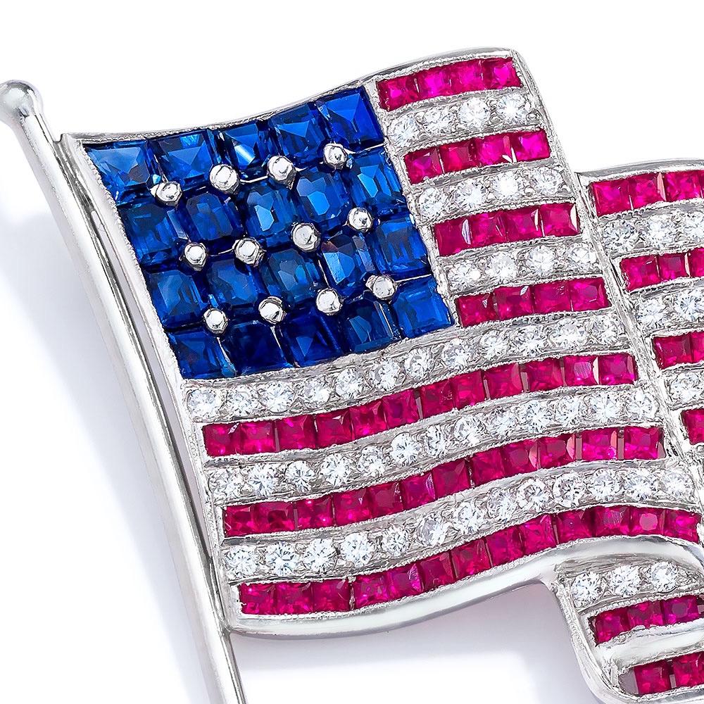 Show off your patriotism with this platinum American flag brooch composed of square cut rubies and sapphires and princess cut and round brilliant diamonds.
Stamped 950 PLAT

119 diamonds: 2.68 carats total.
119 rubies: 5.24 carats total.
20