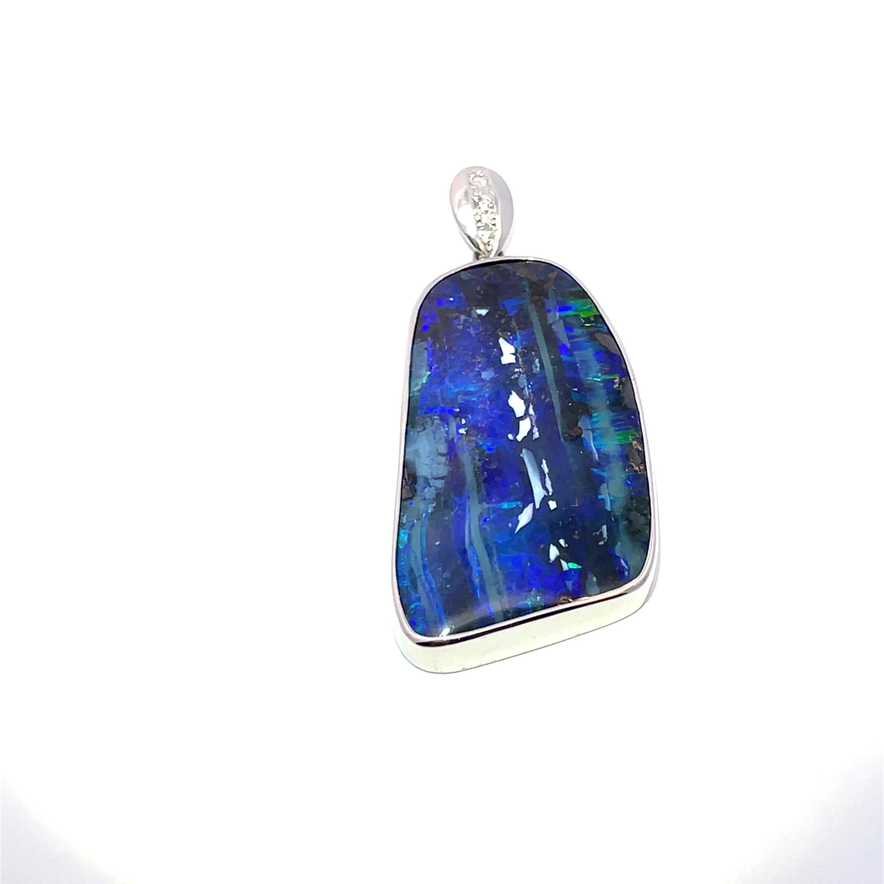 Elevate your jewelry collection with this stunning platinum pendant featuring a mesmerizing boulder opal, showcasing a captivating blend of blue and black hues. Weighing an impressive 61.17 carats, the opal is the centerpiece of this exquisite