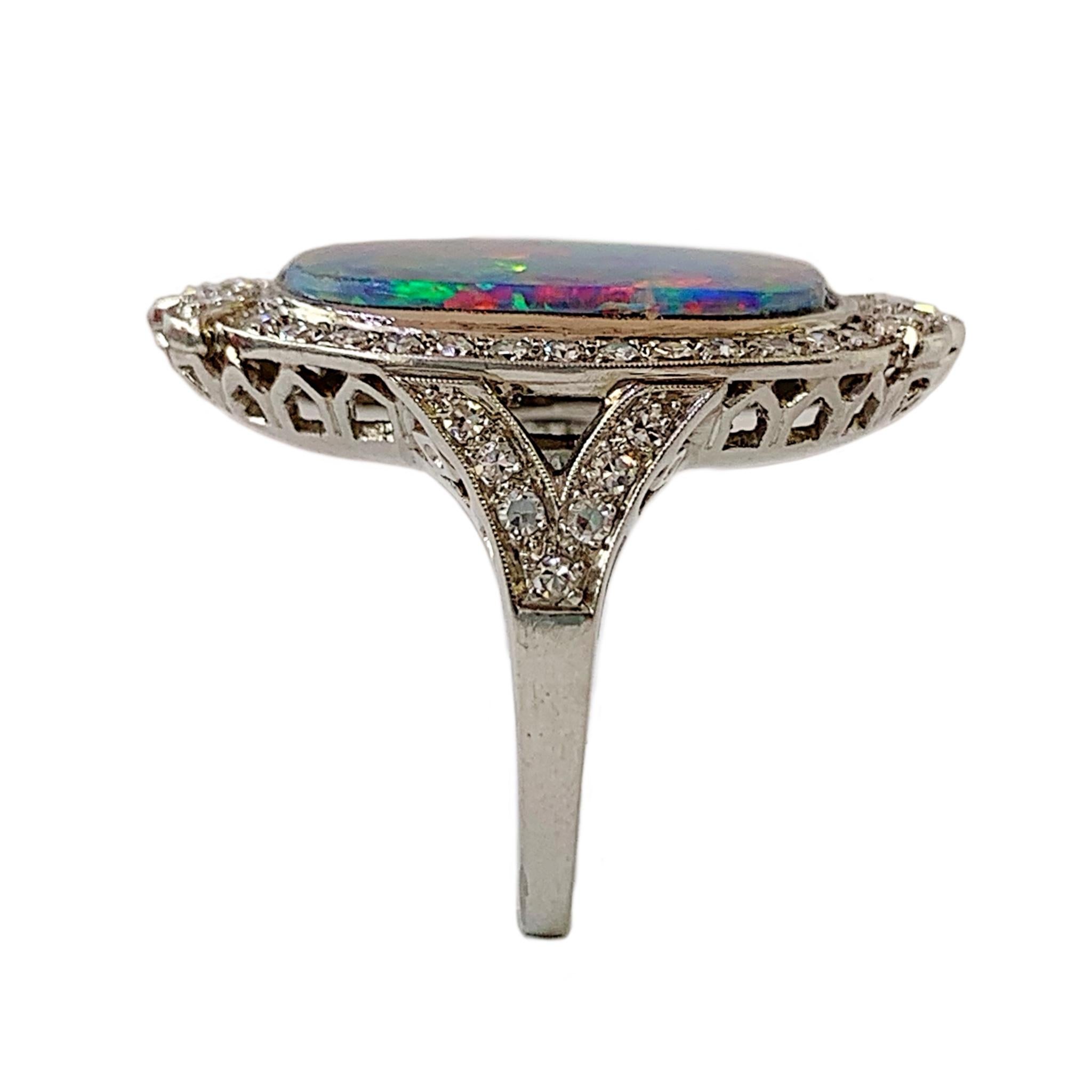 Platinum art deco beauty circa 1940's. The black opal doublet measures 18.75x4.4x4.3mm. It has 46 brilliant  and single cut diamonds with a total weight of approximately 0.97cts. They average VS2-SI2 clarity and rate G-H color. It weighs 11 grams