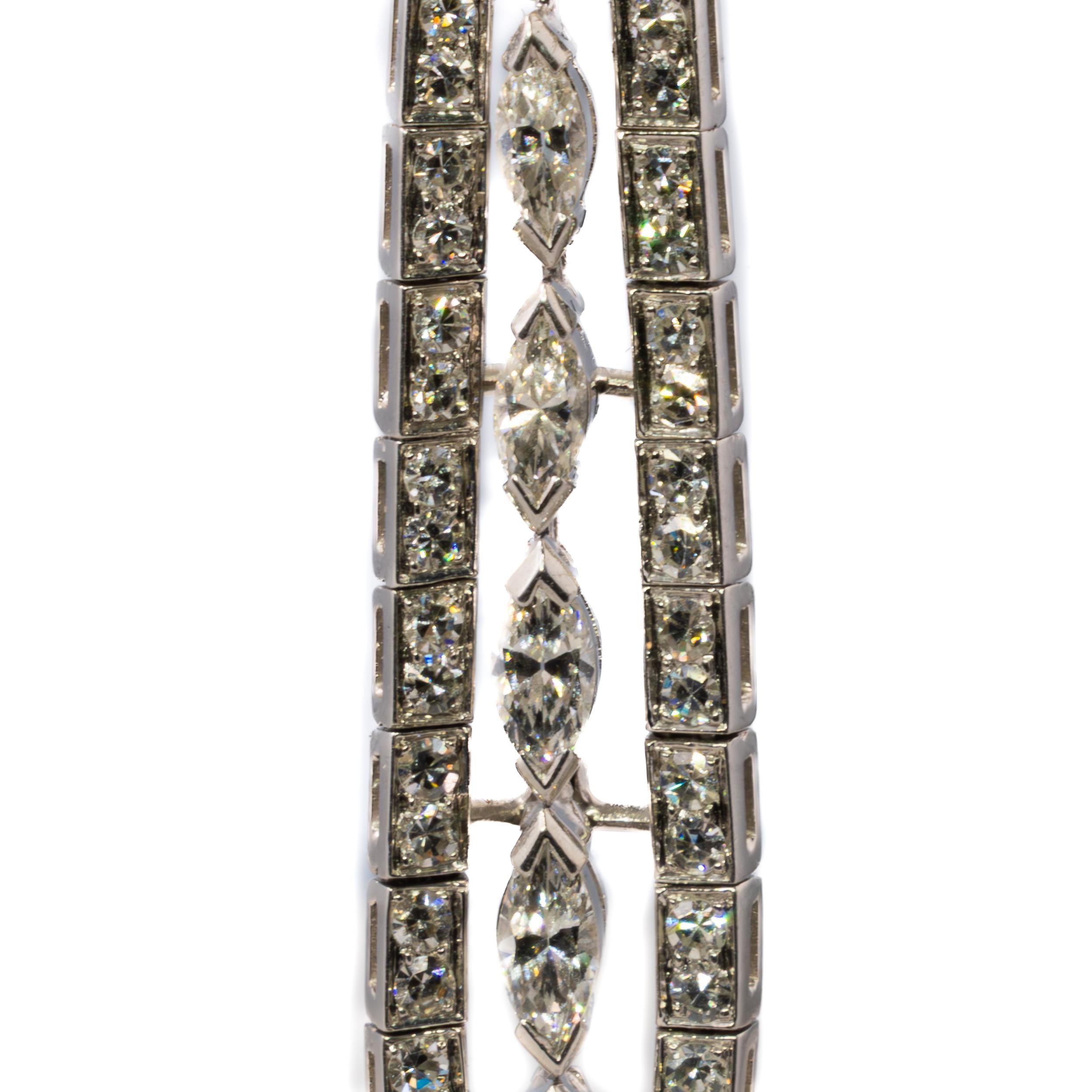Platinum Marquise and Round Diamond Tapered Drop Earrings

Description:
These refined diamond drop earrings feature an elongated silhouette adorned with a striking combination of 12 marquise-cut diamonds and 98 round brilliant diamonds, weighing