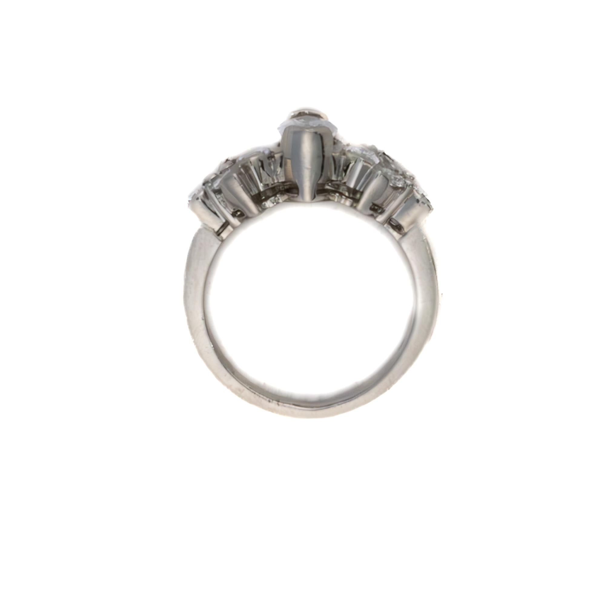 Platinum Marquise 
Brilliant Cut Diamond Band

Description: This platinum ring showcases a bright marquise-cut diamond at its center, framed by a sculpted cluster of round brilliant diamonds set in softly contoured, petal-like bezels that flow