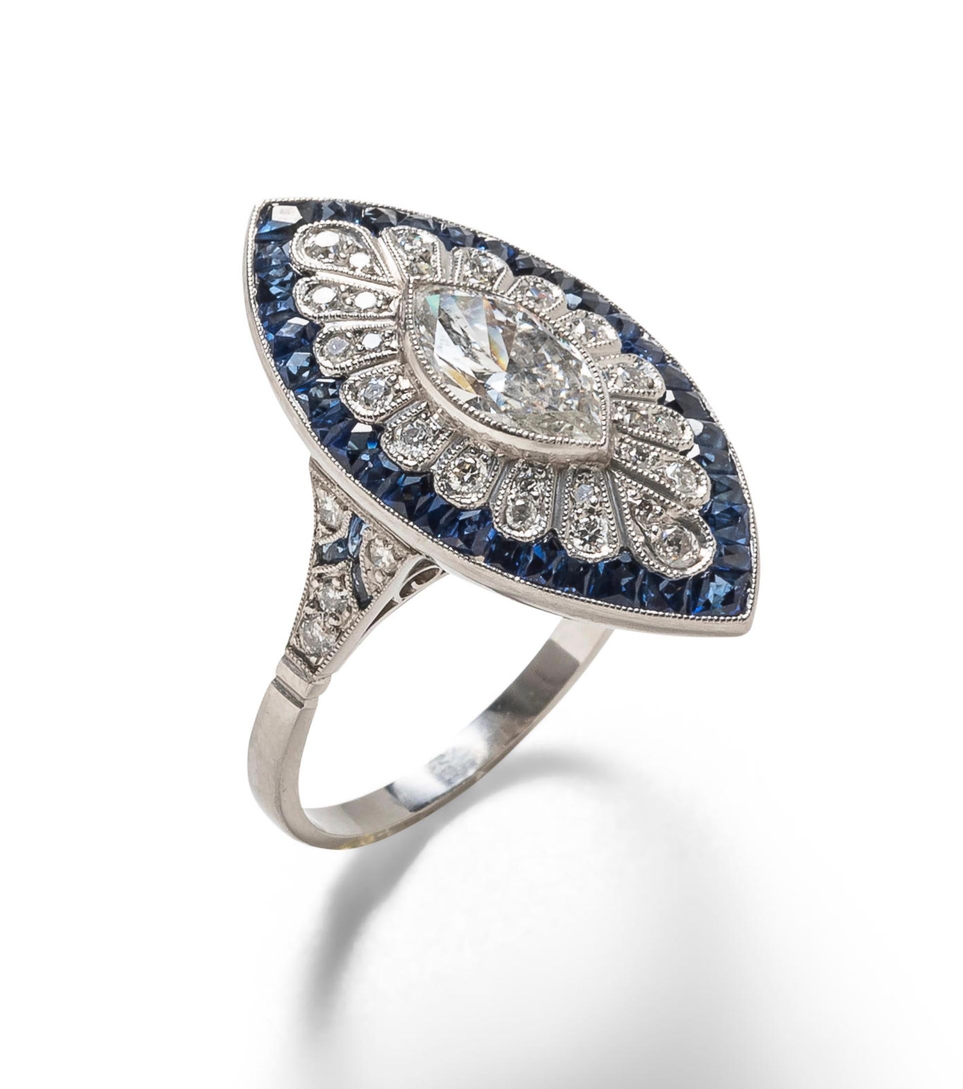 Platinum marquise diamond ring

Bezel-set marquise-cut diamond of approximately 1 carat, framed by circular-cut diamonds and calibre-cut sapphires, millegrain accents; platinum 

Size: 7.5 US; head width 0.5 inch, length 1 inch 
Total weight: 7.3