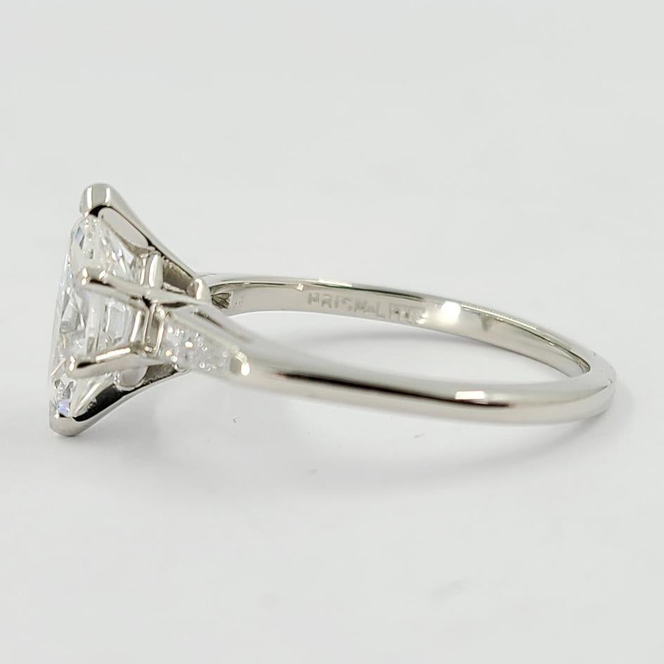 Platinum Three Stone Diamond Ring Featuring A 1.10 Carat Marquise Cut Diamond GIA Graded (Report #6214393306) As E Color & VS2 Clarity. 2 Tapered Baguette Diamonds Accent The Center Stone, Totaling 0.15 Additional Carats. Current Finger Size Is 6.5;