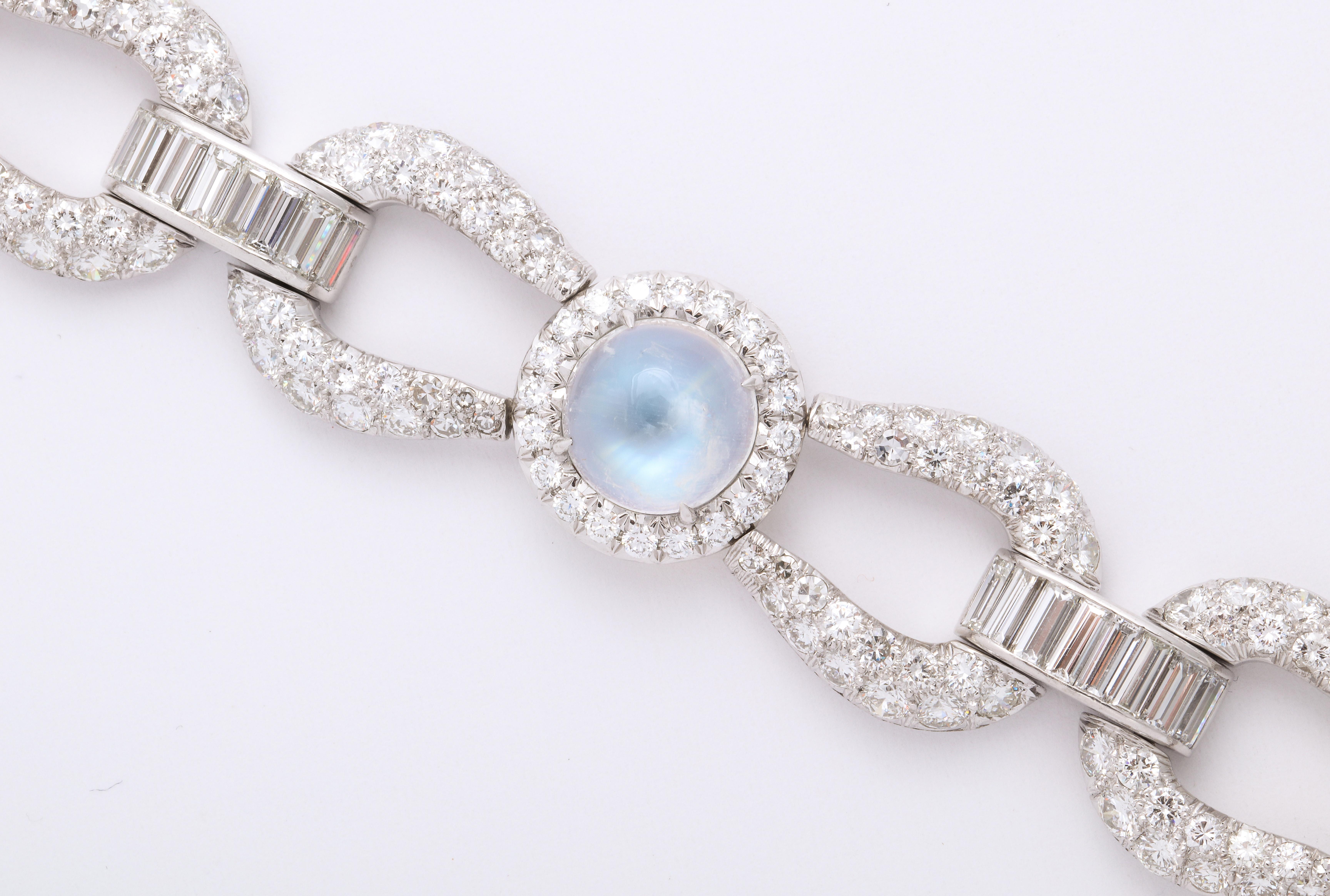 This gorgeous french bracelet is perfect for the estate jewelry lover as well as the modern enthusiast.  Three large, round cabochon moonstones of extraordinary clarity and color are featured in this platinum mid-century link bracelet made in