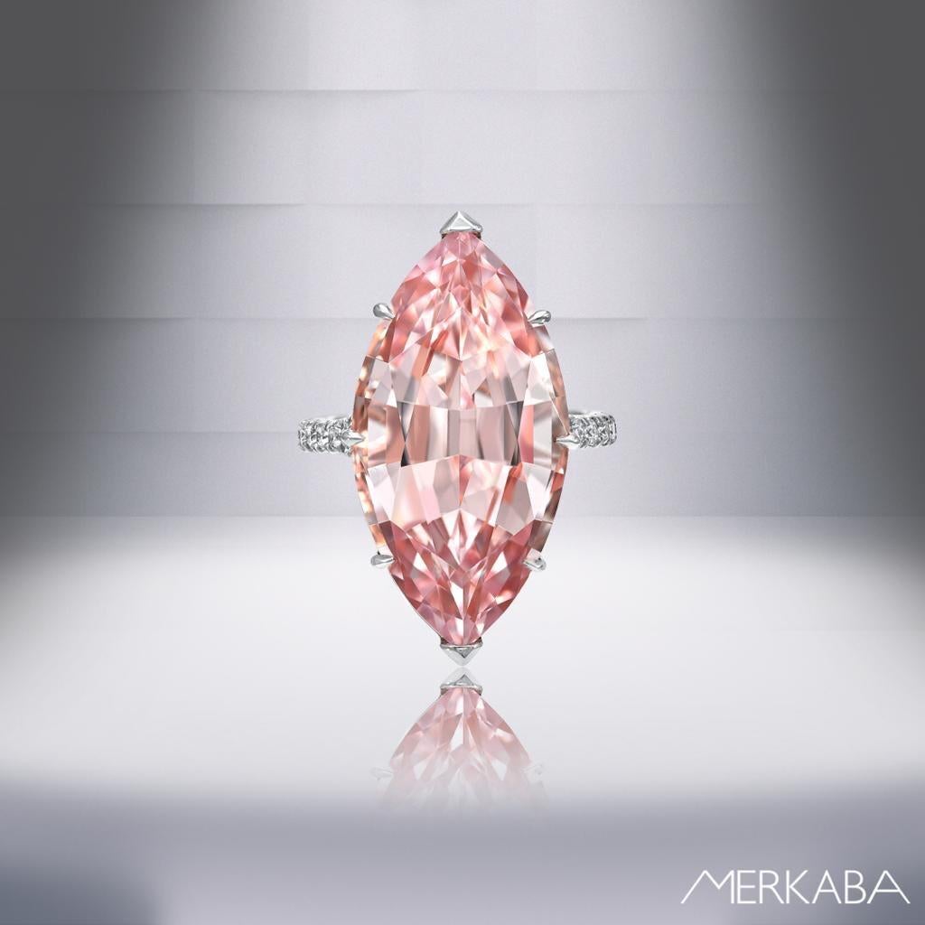Impressive 14.54 carat marquise Morganite, exhibiting superior cut and clarity, is set in this ultra fine 6 claw prong setting, and adorned by a total of 0.38 carat round brilliant diamonds carefully set on the split styled shank. Crafted by