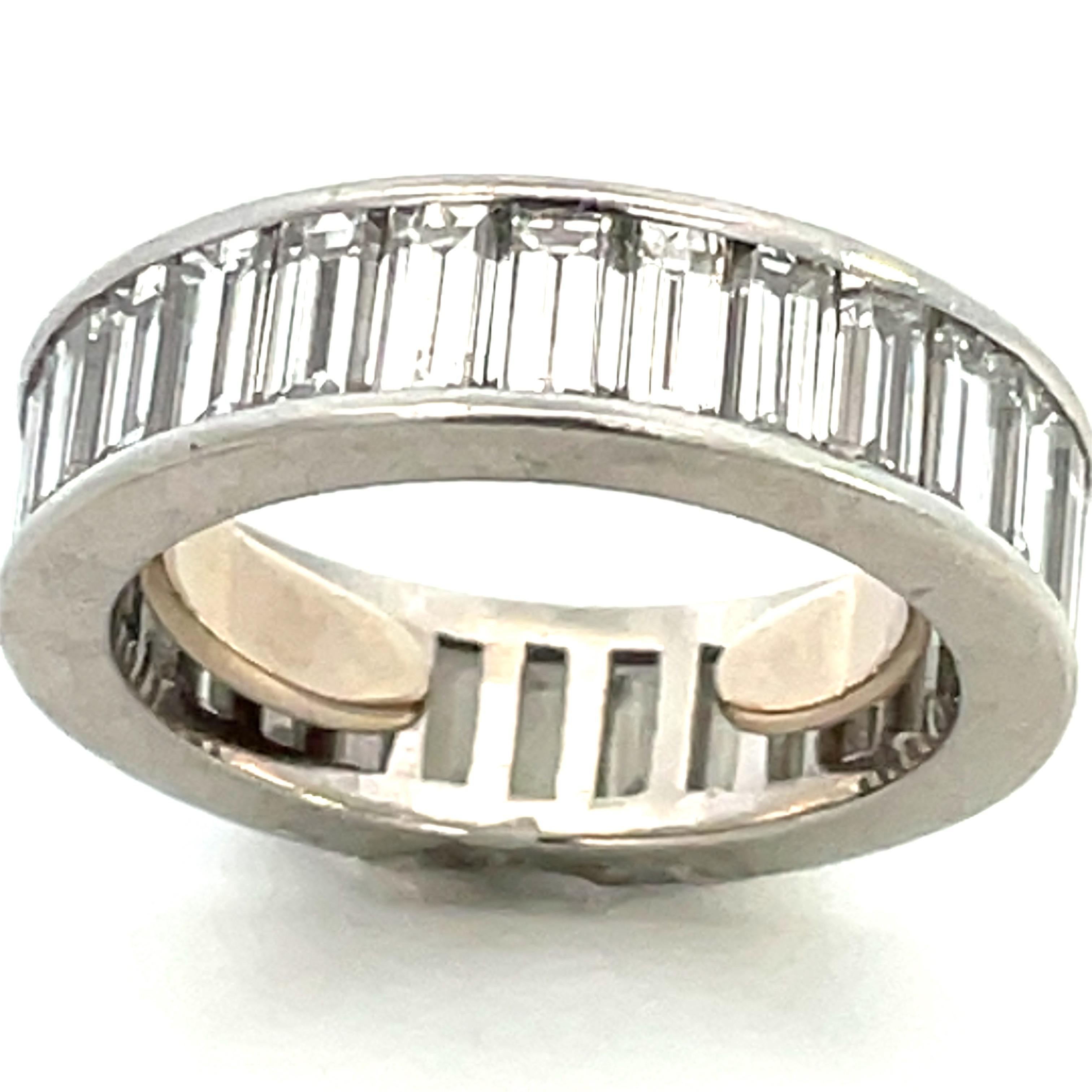 A classic because of the style: a single row of large, clean, white baguette diamonds encircling the finger.  The secret surprise here is the ring’s size:  with the interior sizing collar as pictured, it’s a size 7, a wonderfully average size for a