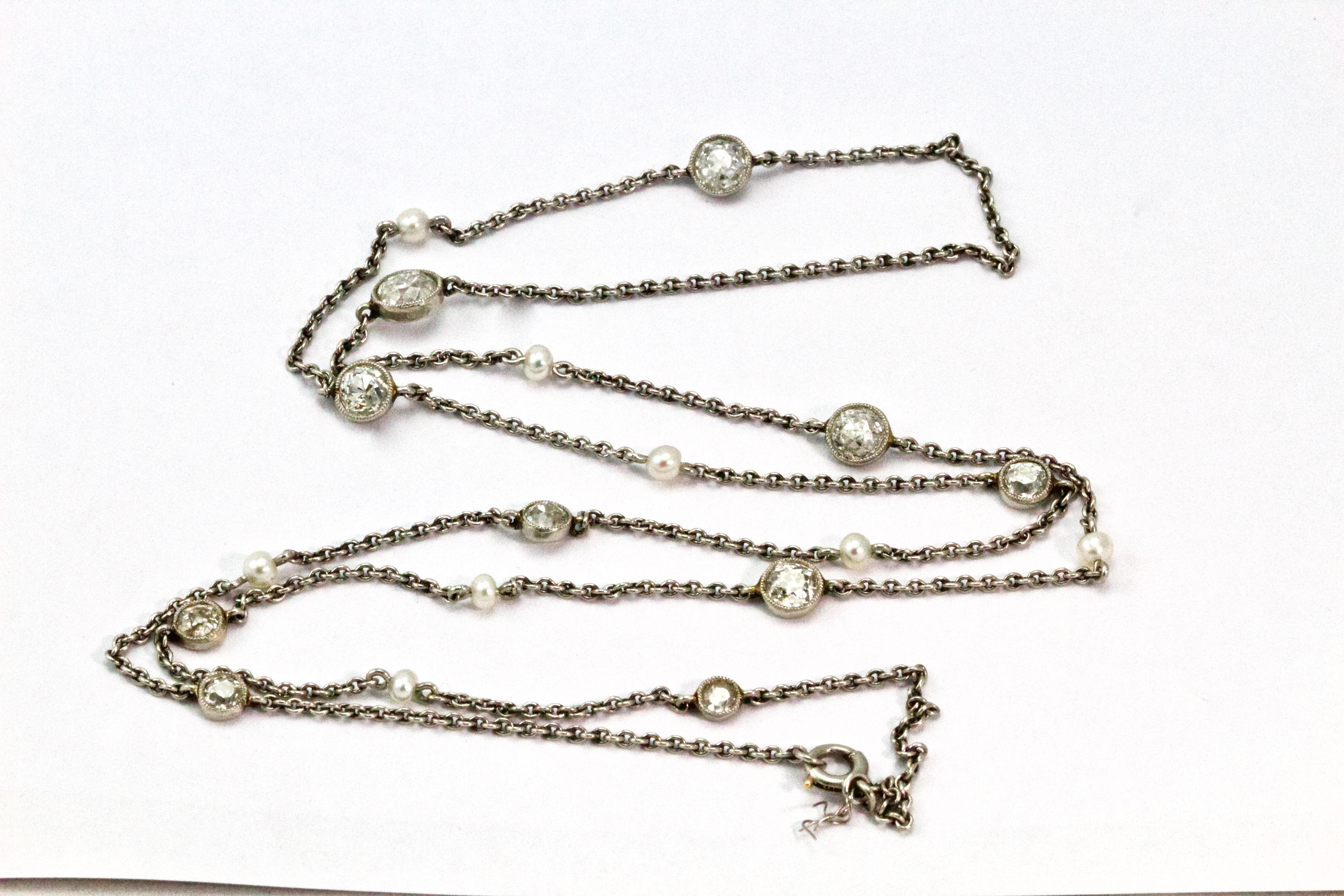 Fashioned circa 1920s this Art Deco long chain is comprised of platinum cable style links to give a chain of approximately 22 inches long. Beautifully embellished with 10 graduating Old European cut diamonds alternated with 8 natural pearls. 
Weight
