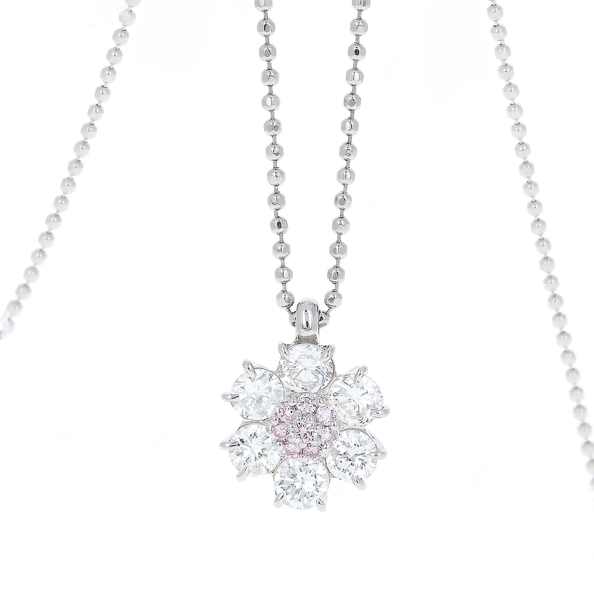Platinum diamond flower pendant with pink and white diamonds. 
There is 0.07 carats of natural pink diamonds and 0.95 carats total weight in white diamonds.

The chain is 16 inches in length
