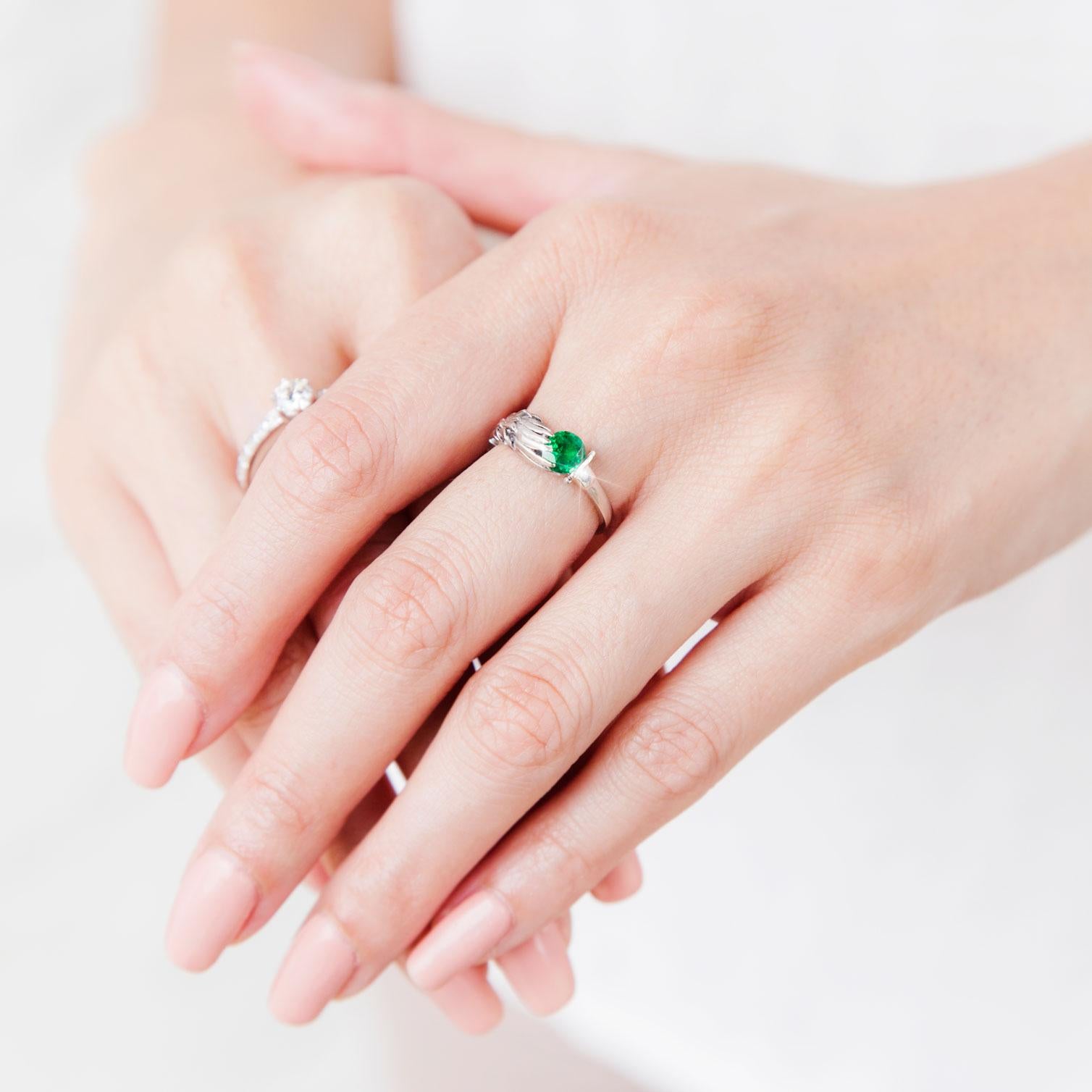 Forged in platinum, this vintage emerald ring is empowered with fantasy. The Yuna Fantasy Ring sees a mythical feathered wing sweeping up one side of the ring, ending in a set of fierce claws and grasping at a magical natural green emerald,