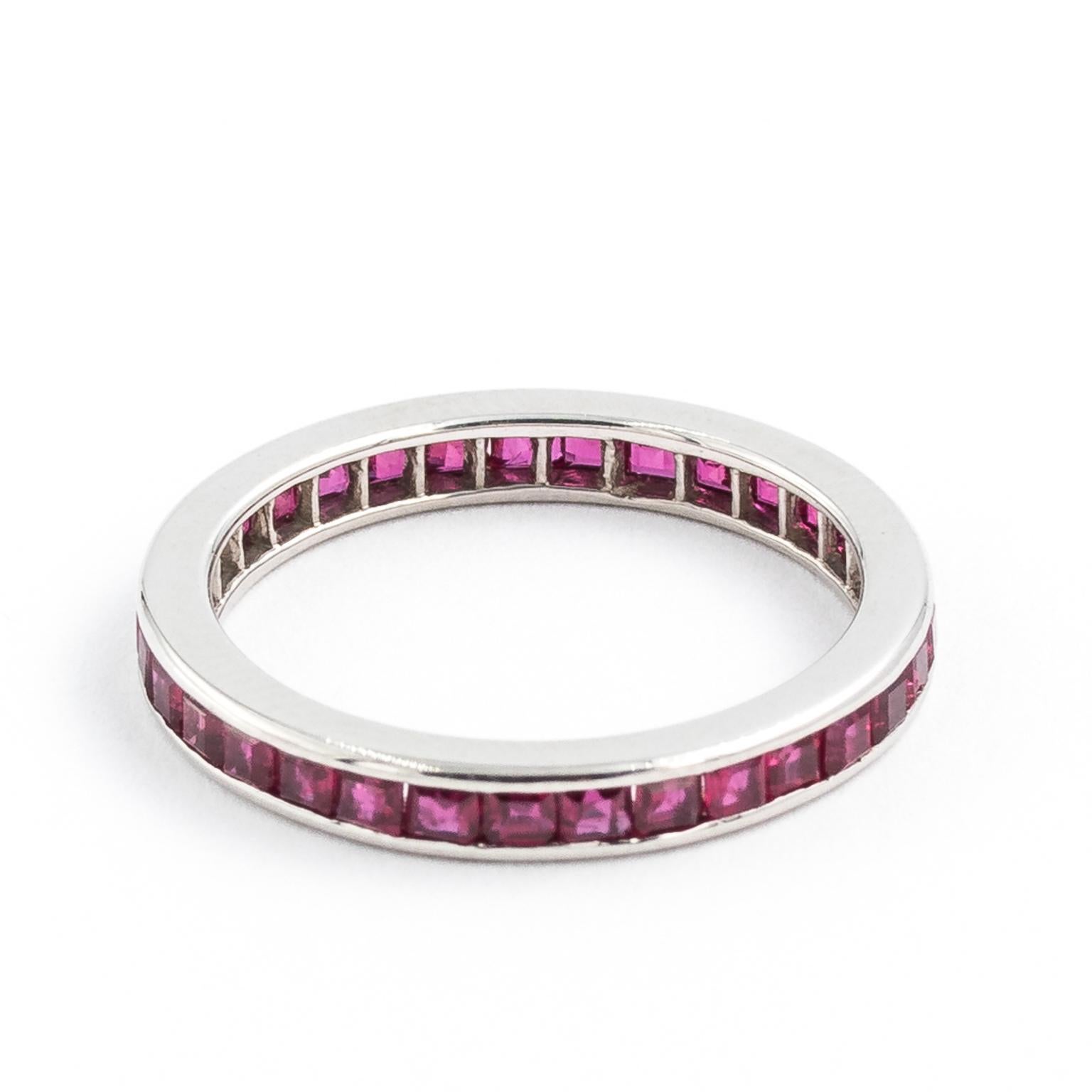 Constructed from solid platinum, the ring has an array of princess cut high quality natural Burma rubies invisible set along the platinum band. The rubies are carefully selected with matching color, highly transparent, only one or two of them has