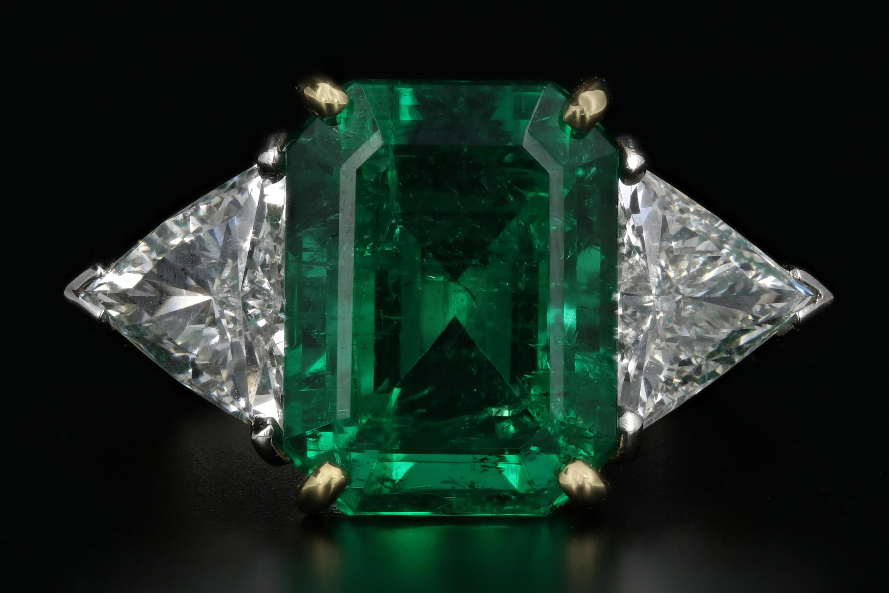 Era: Modern

Composition: 18K Yellow Gold & Platinum

Primary Stone: Natural Zambian Emerald

Carat Weight: 5.58 Carat

Clarity: Standard

Degree: Minor

Type: Traditional

Secondary Stone: Diamond

Carat Weight: 1 Carat Each ( 2 CTW)

Color: