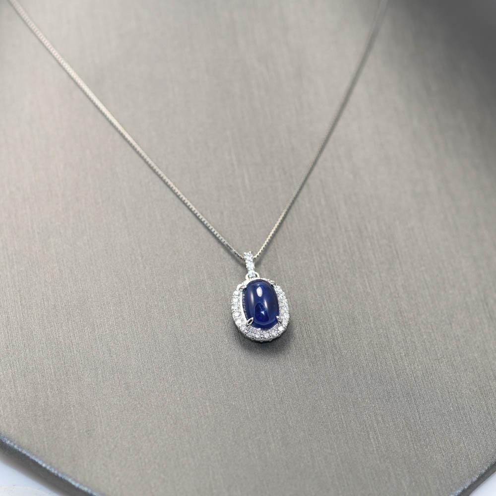 Ladies sapphire and diamond pendant necklace in platinum setting.
The chain is stamped Pt 850 and the pendant is stamped Pt900.
Gross weight is 5.1 grams.
The natural sapphire is a cabochon cut, 3.64 carats, deep blue, excellent clarity.
The