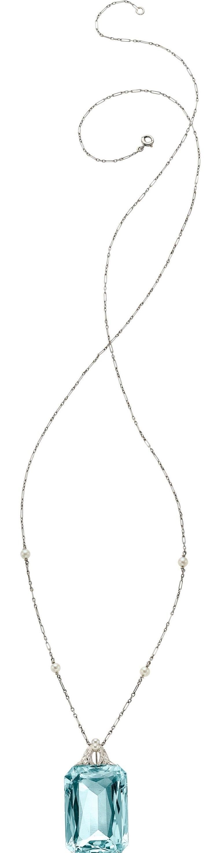 Beautiful Art Deco Style Pendant With an Aquamarine Center Stone Accented with Diamonds and Seed Pearls
Aquamarine Weight: ~50 Carats.
Aquamarine Measurements: 29.13 mm x 19.93 mm x 10.71 mm.
Features Seed Pearls Ranging from 2.50 mm to 3.25 mm