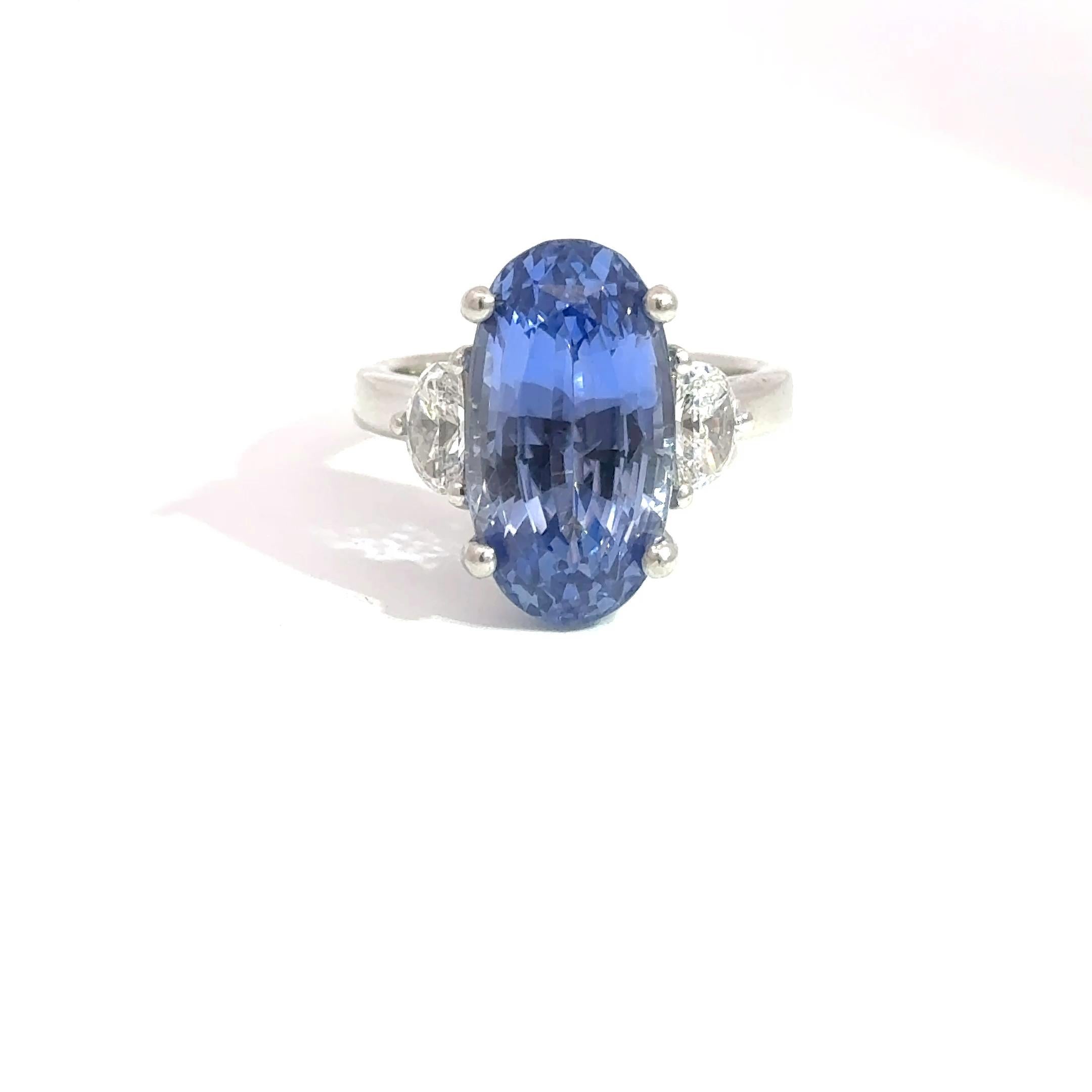 Showcasing a breathtaking 9.61 carat unheated sapphire, this platinum ring is an extraordinary statement of rarity and refinement. The rich royal blue hue of the center stone is emphasized by a pair of sparkling moon-cut diamonds weighing a total of