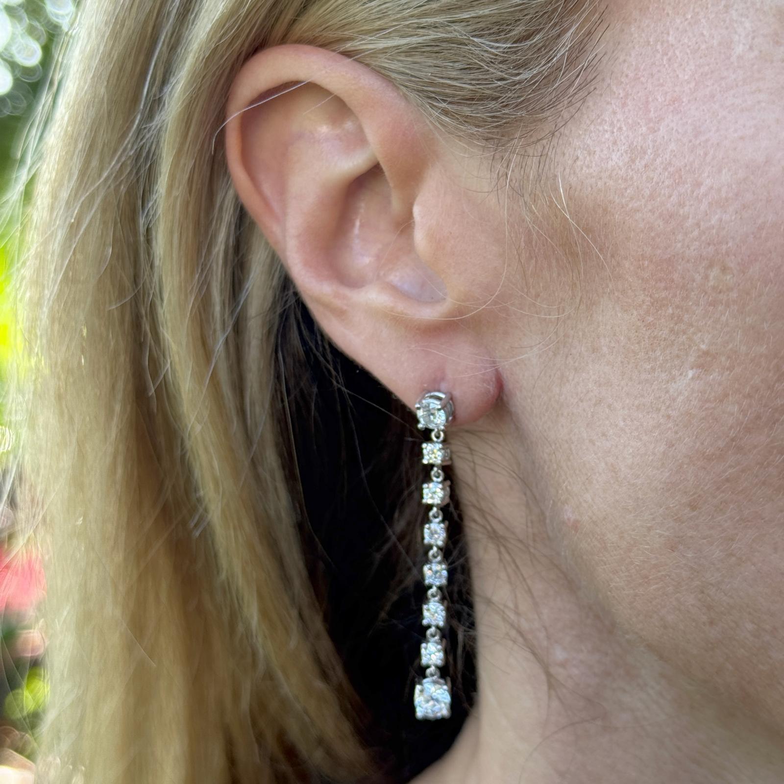 These exquisite platinum diamond drop earrings feature a dazzling array of Old European Cut diamonds with a total carat weight of approximately 2.98 carats. Each earring is set with one larger OEC diamond of ~1.00 carat and a secondary OEC of ~0.50
