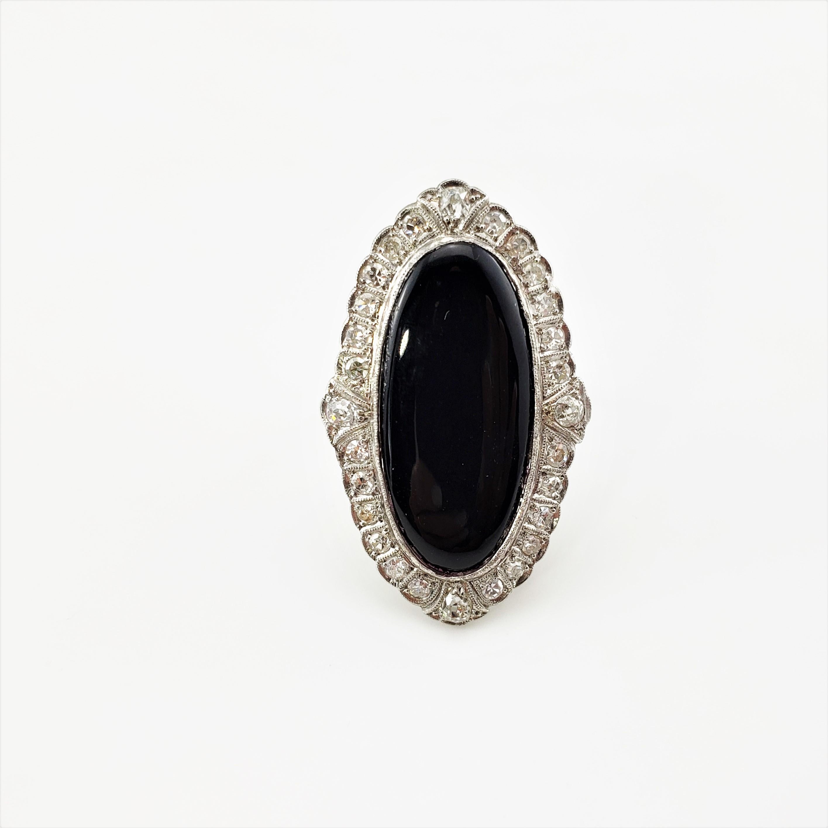 Platinum Onyx and Diamond Ring Size 7-

This stunning ring features one oval onyx stone (28 mm x 14 mm) surrounded 28 round old mine cut diamonds set in classic platinum.  Top of ring measures 38 mm x 23 mm.  Shank measures 1.5 mm.

Approximate