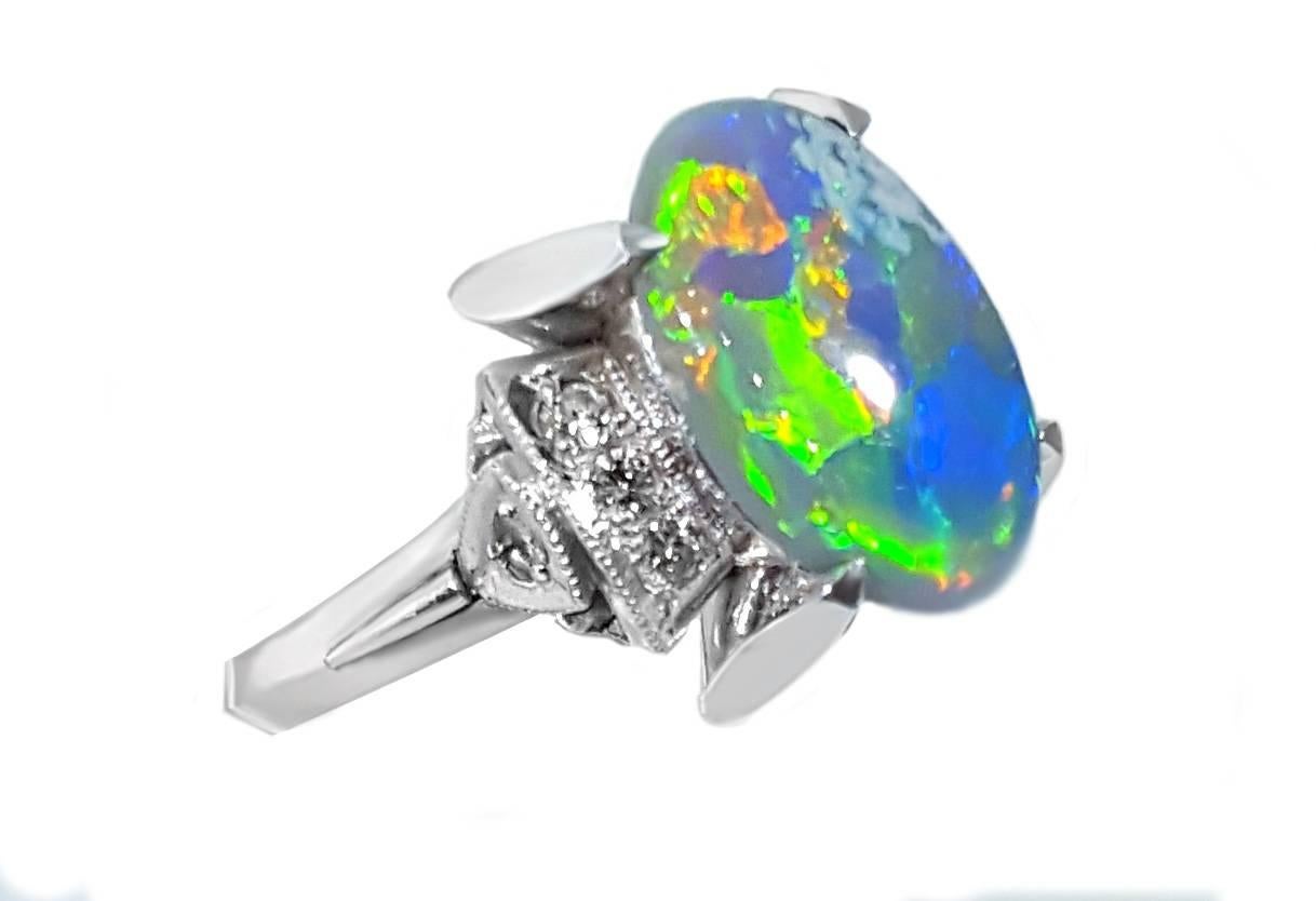 A dreamy 2.13ct oval opal sits at the center of a high polished platinum mounting, surrounded by .12ctw of diamond accents. Ring is a US size 5.75