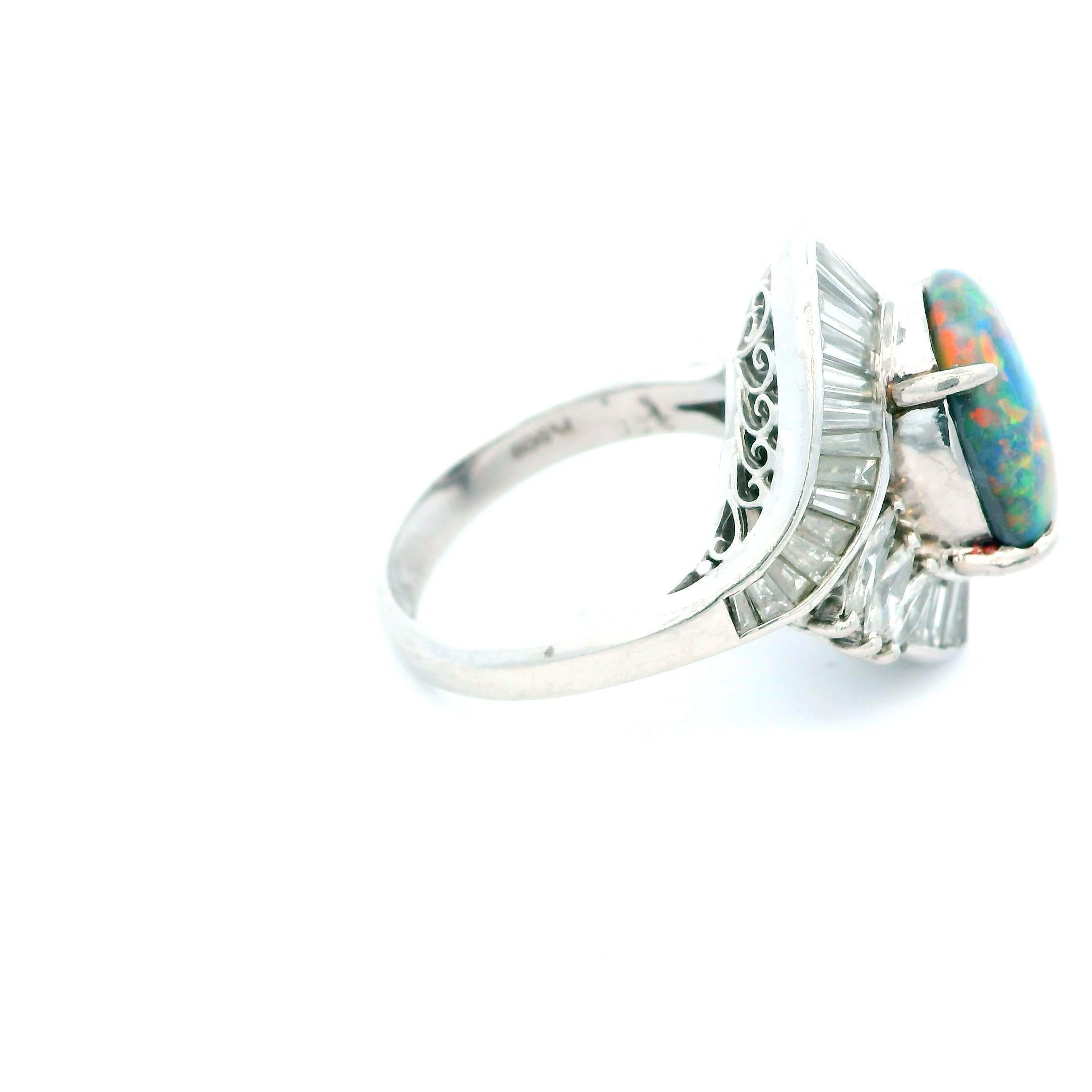 A striking black opal ring from the 21st century.

This exquisite platinum ring features a captivating cabochon cut black opal weighing 3.38 carats. The opal displays a mesmerizing play of colors, set in a secure prong setting that enhances its