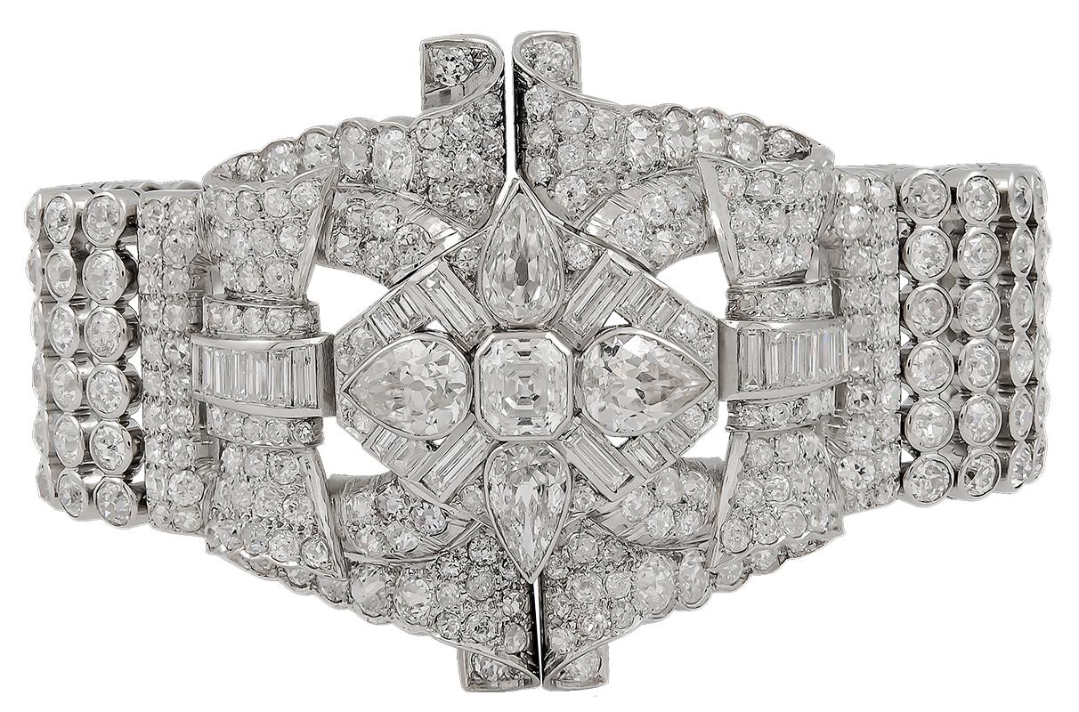 Of openwork design, the three-dimensional central motif decorated with scrollwork and stylized bows, set throughout with old European, single-cut, baguette, pear-shaped and Asscher cut diamonds.
diamond weighing a total of approximately 45