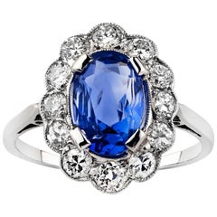 Antique Platinum Oval Ceylon Sapphire and Semi Modern Cut Diamond Scalloped Cluster Ring
