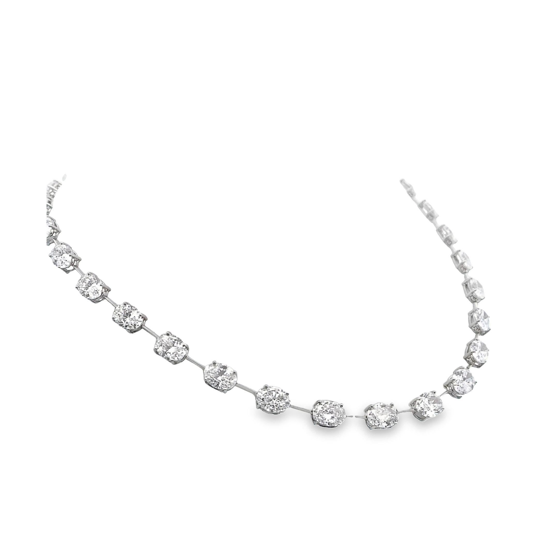 This luxurious necklace, crafted in platinum, features an impressive 31.1 carats of prong-set white oval diamonds. The diamonds are meticulously arranged along the length of the necklace, allowing for maximum brilliance and sparkle. The classic