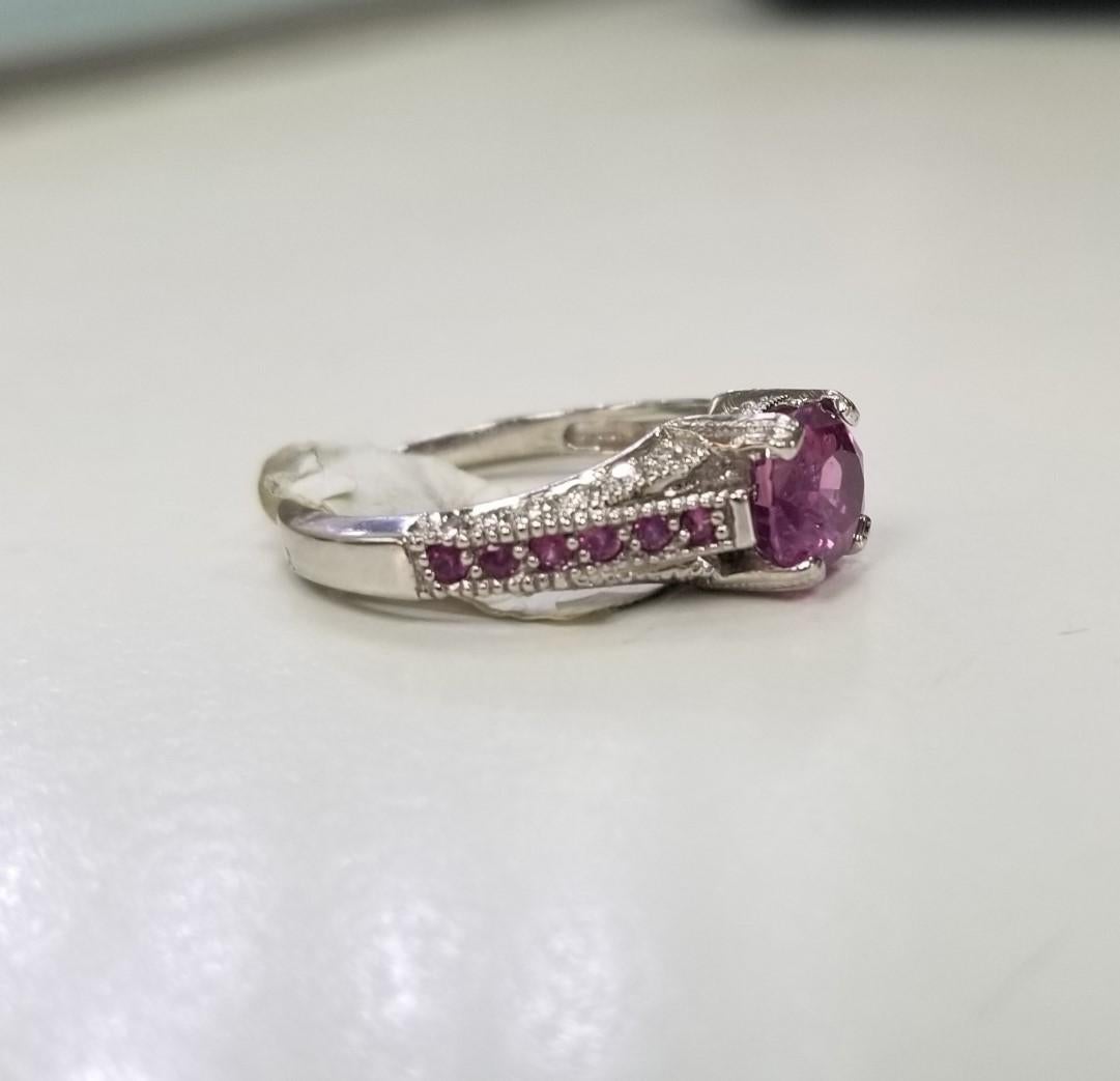 Specifications: 
    Metal: Platinum
    Weight: 6.8Gr
    Main Stone: Pink Sapphire 2.24cts.
    Side Stones: 24 Diamonds    
    Weight: .24pts.
    Color: G
    Clarity: VS
    Size: 7 US






